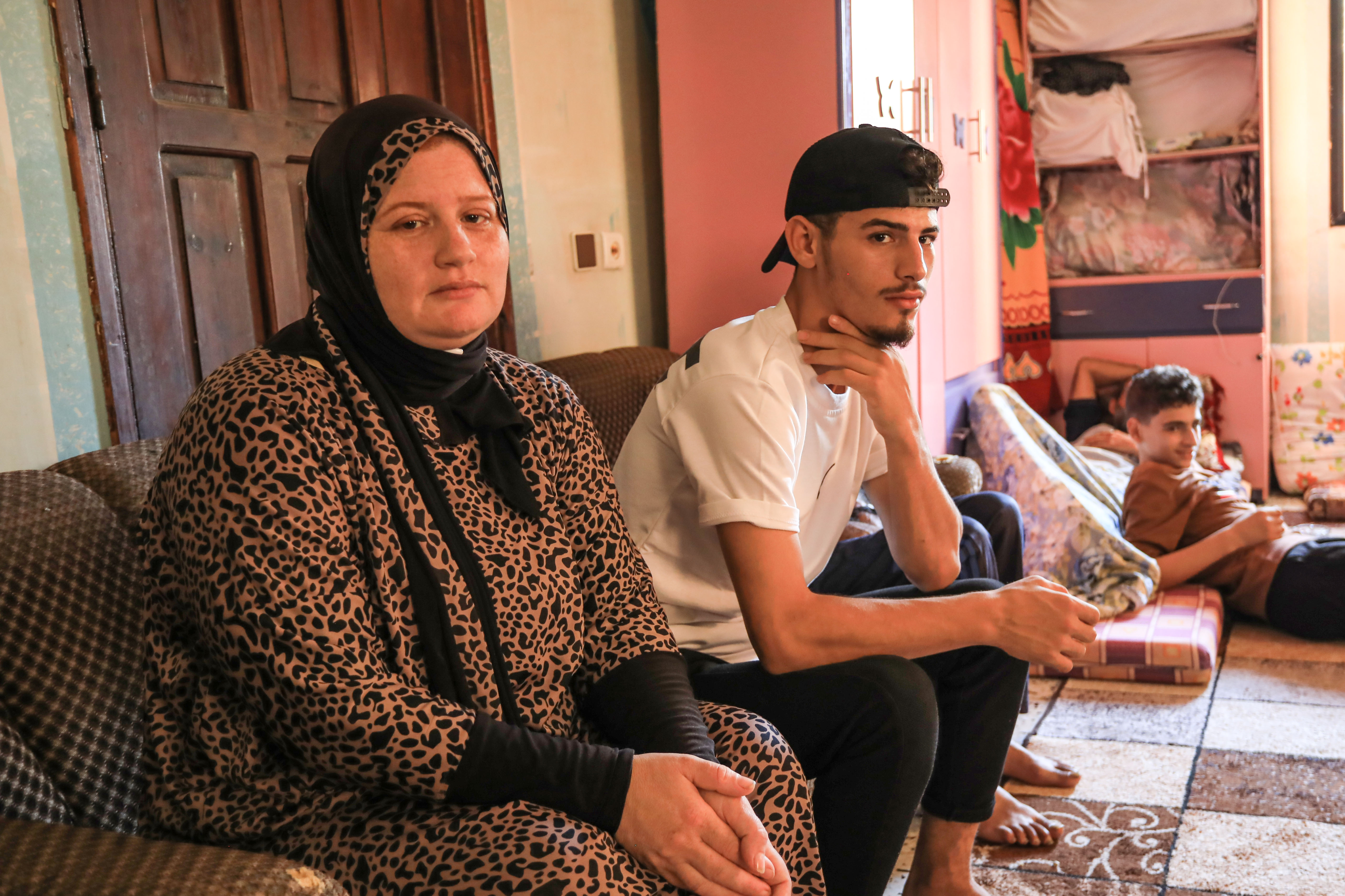 Ola al-Saeedi and her son Khader in a relative's house in the central town of Deir al-Balah
