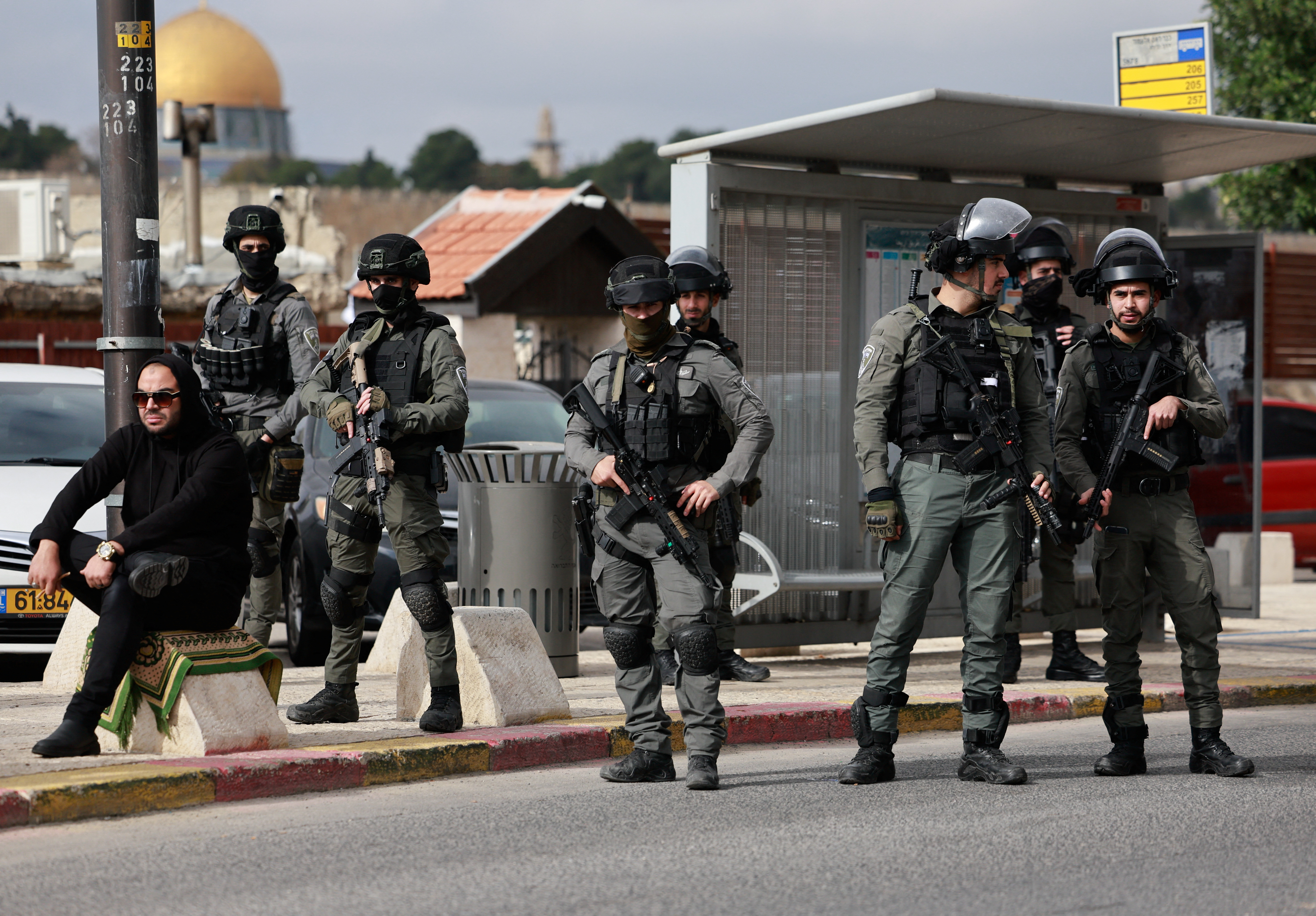 Israeli Border Police officers stand guard, while Palestinian Muslims hold Friday prayers, as the conflict between Israel and the Palestinian Islamist group Hamas continues, in Jerusalem, December 29