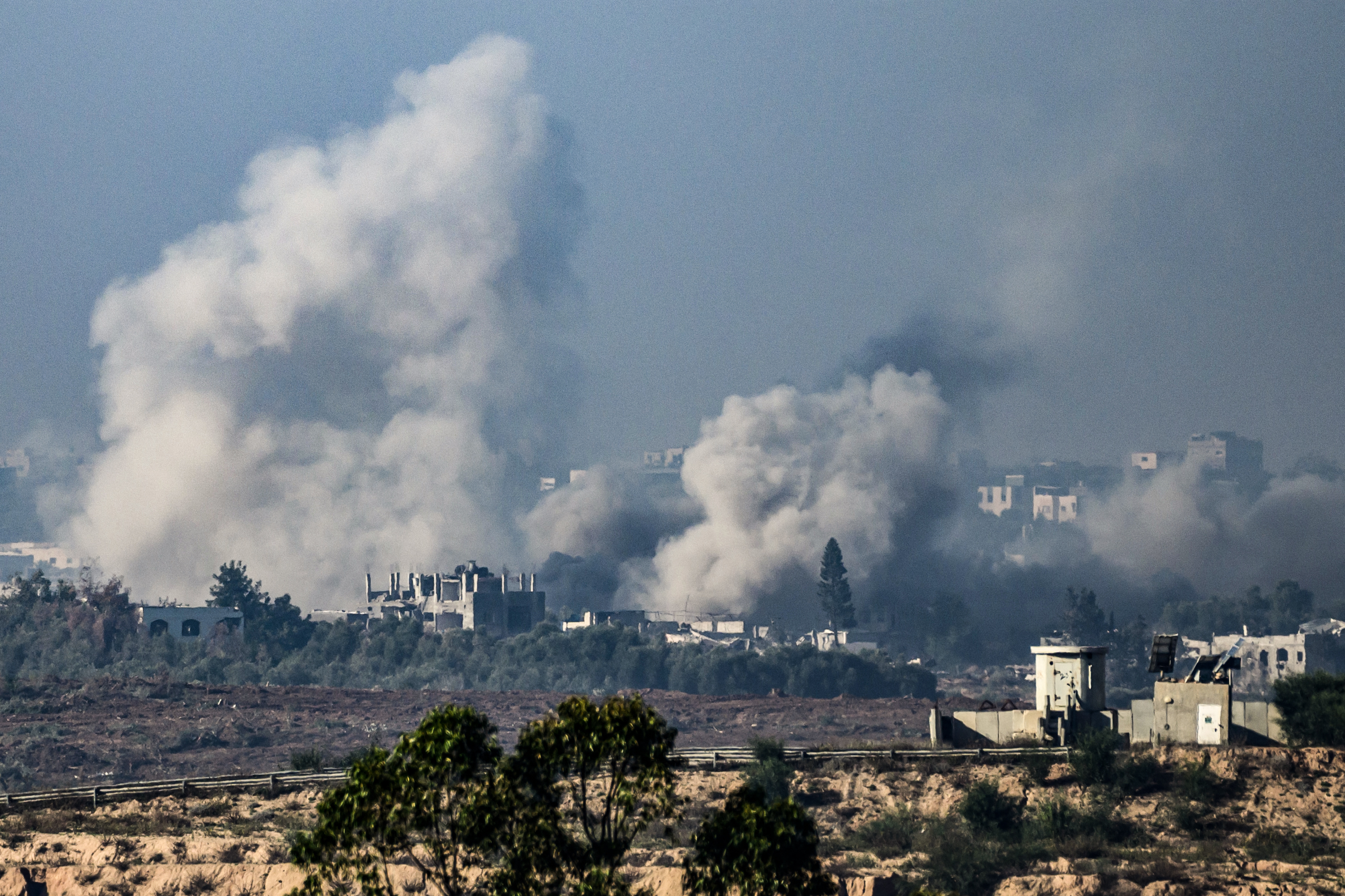 This picture taken from the northern Gaza Strip shows smoke rising from buildings still after being hit by Israeli strikes in the battles between Israel and Hamas.
