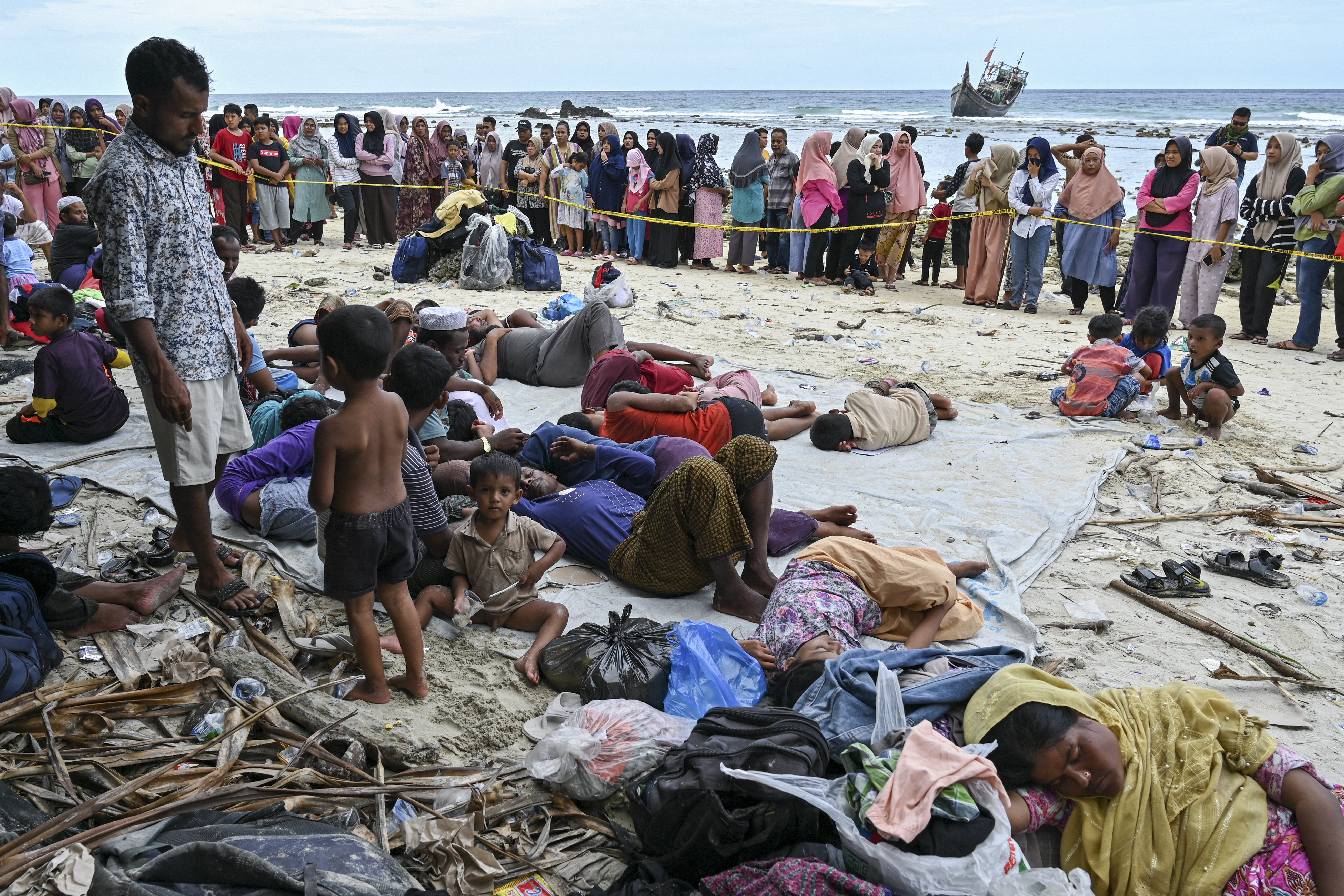 Newly-arrived Rohingya refugees rest at a beach on Sabang island, Aceh province, on December 2