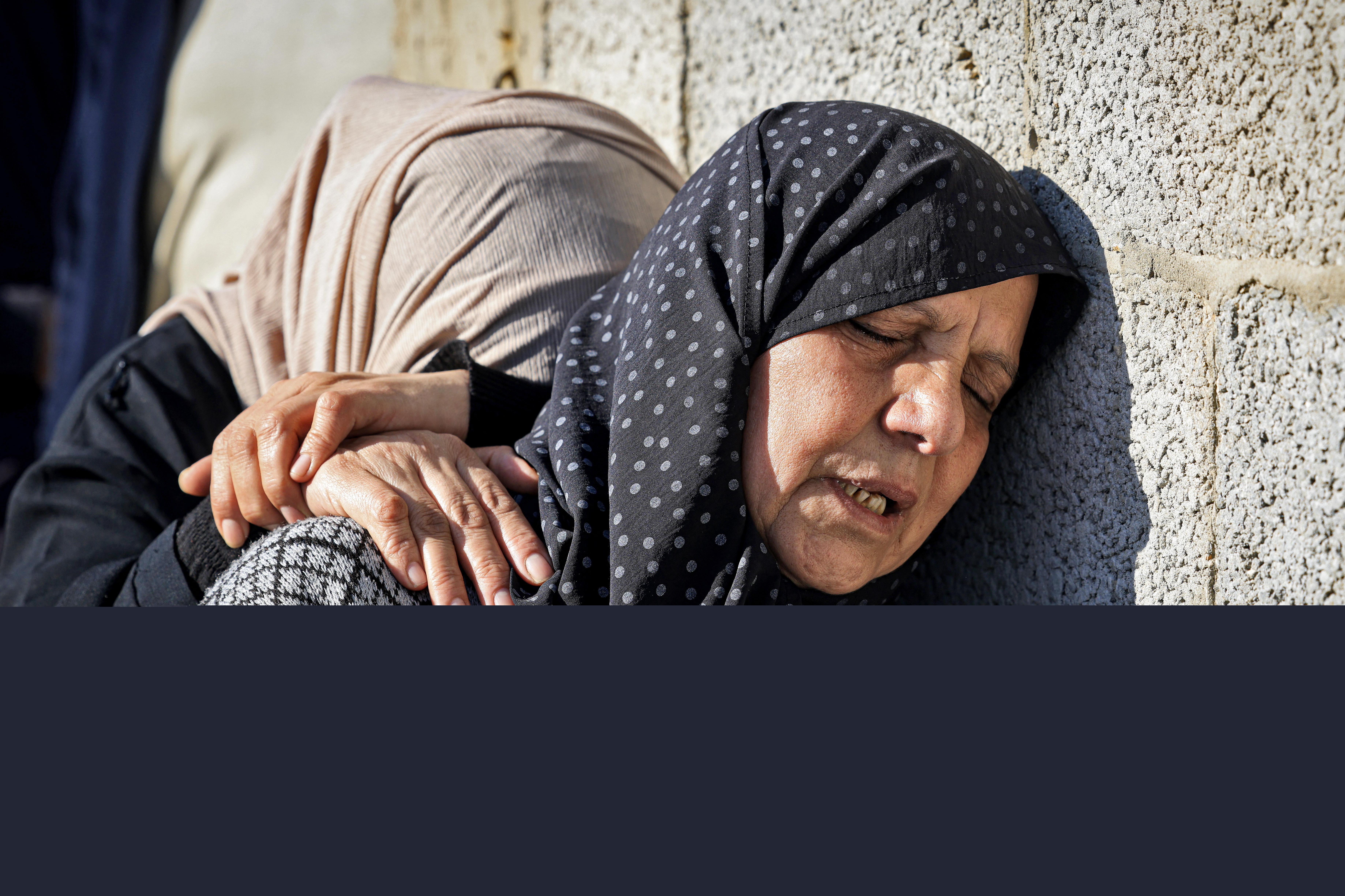Relatives mourn during the funeral of Al Jazeera cameraman Samer Abu Daqa, who was killed during Israeli bombardment, in Khan Yunis on the southern Gaza Strip on December 16, 2023, amid the continuing battles between Israel and the militant group Hamas. - An Israeli attack killed an Al Jazeera journalist and wounded his colleague in the Gaza Strip on December 15