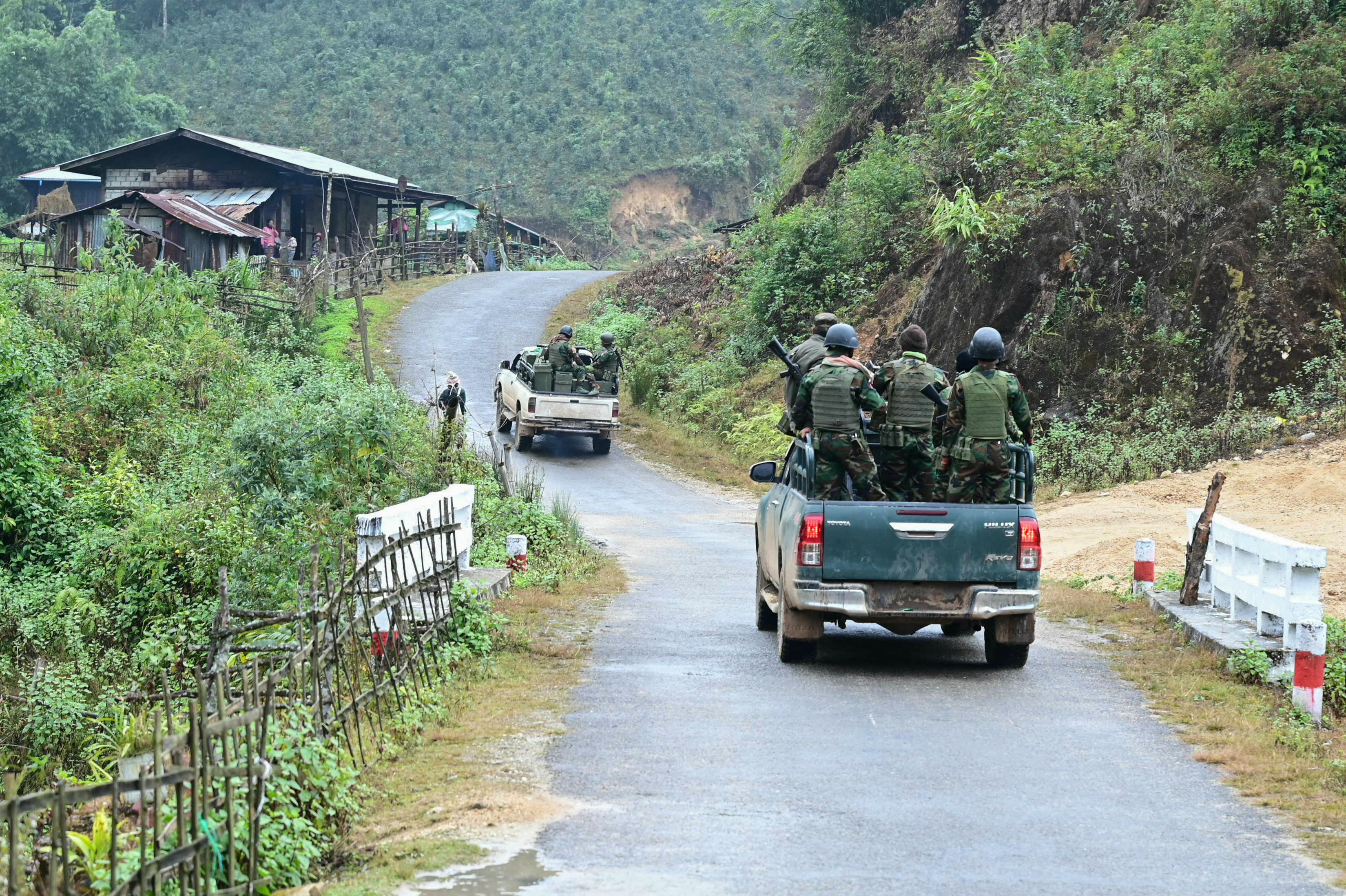 This photo taken on December 13, 2023 shows a member of ethnic minority armed group Ta'ang National Liberation Army (TNLA) standing guard at a hill camp seized from Myanmar's military in Namhsan Township in Myanmar's northern Shan State.
