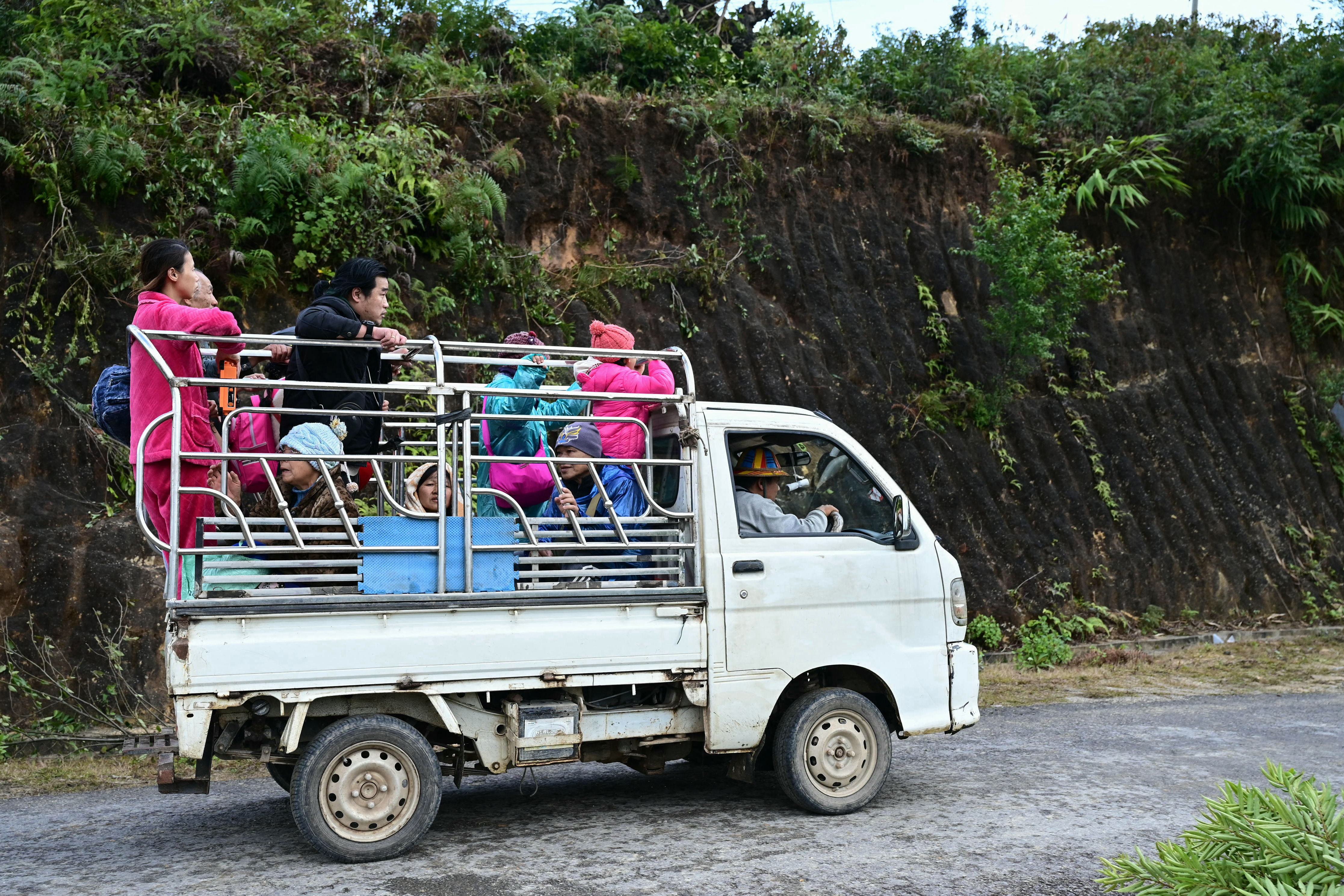 This photo taken on December 13, 2023 shows local residents leaving their homes during clashes between the ethnic minority armed group Ta'ang National Liberation Army (TNLA) and Myanmar's military in Namhsan Township in Myanmar's northern Shan State.
