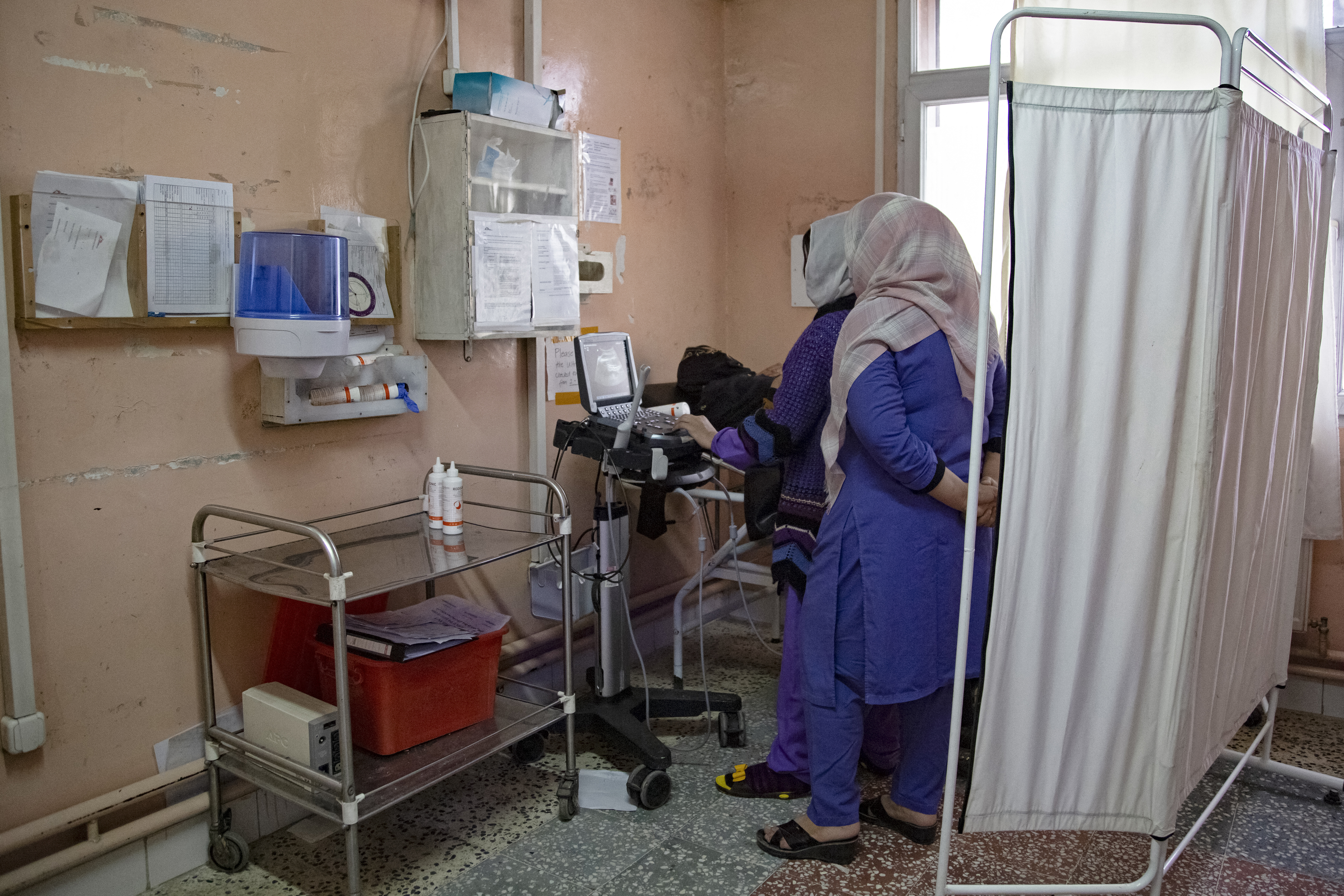 In this photograph taken on December 8, 2023, nurses conduct an ultrasound test for a patient (L) at the Doctors Without Borders (MSF)-run maternity hospital in Khost.