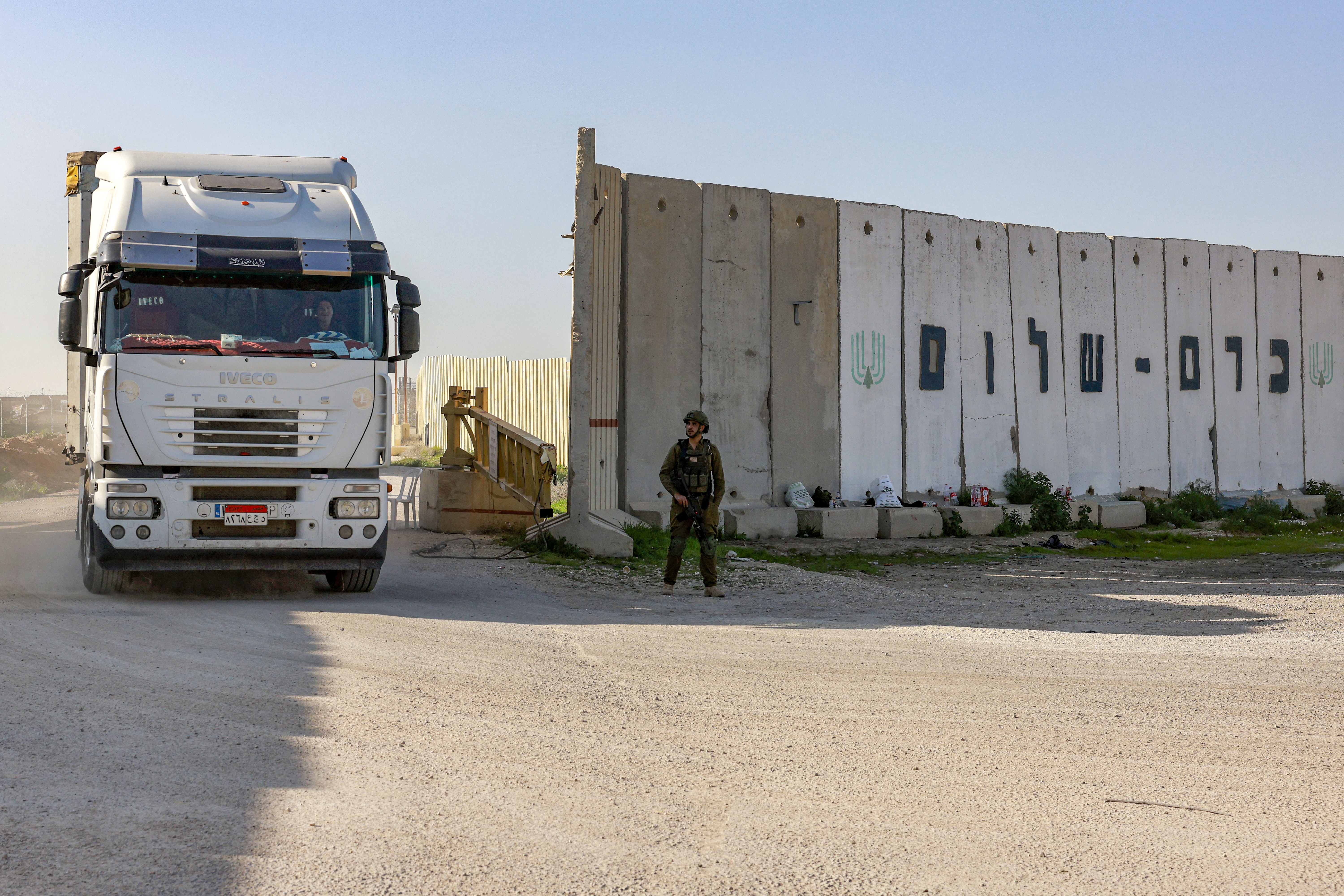 A truck carrying humanitarian aid moves at the Israeli side of the Kerem Shalom border crossing with the southern Gaza Strip on December 19, 2023, amid the ongoing conflict between Israel and the Palestinian militant group Hamas. (Photo by Menahem Kahana / AFP)