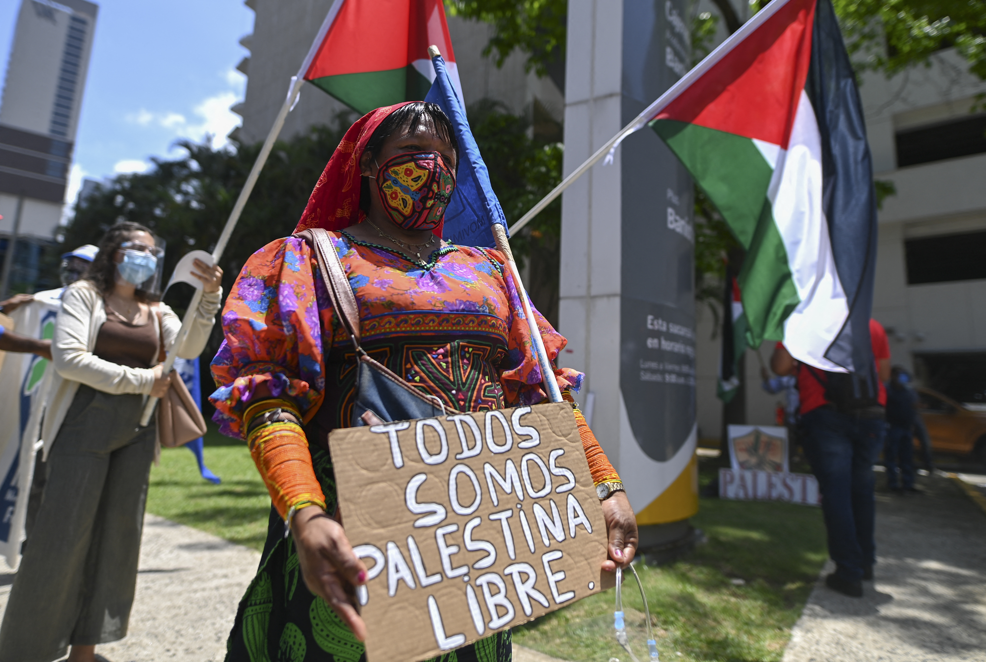 A Kuna indigenous woman joins members of the Palestinian community in Panama protesting outside the Israeli Embassy against Israel's military operations in Gaza and in support of the Palestinian people, in Panama City on May 20, 2021. (Photo by Luis Acosta / AFP)