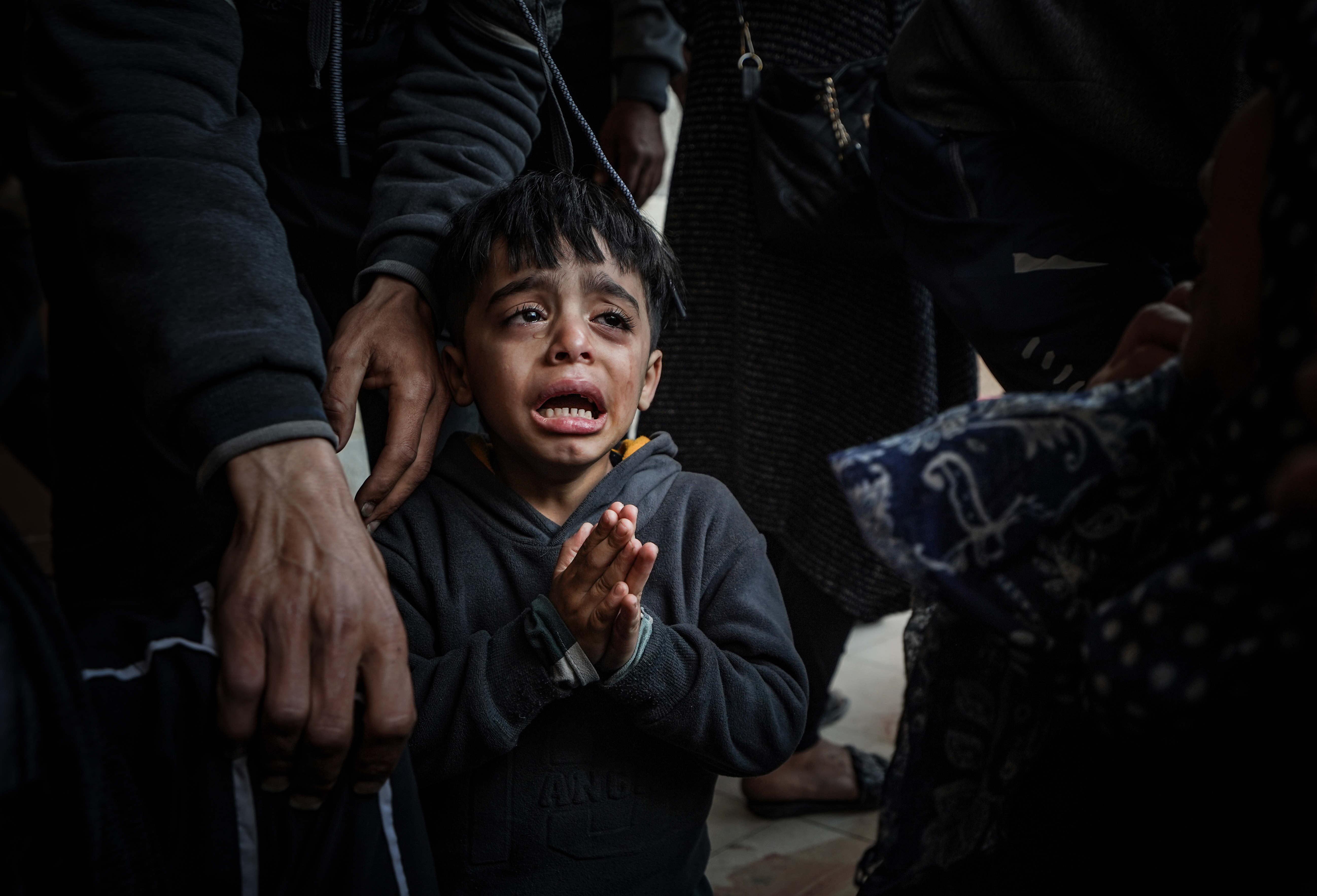 A Palestinian child cries as relatives of the Palestinians died in Israeli attacks mourn as bodies of those killed in the attacks were brought to the morgue of Nasser Hospital in Khan Yunis, Gaza.