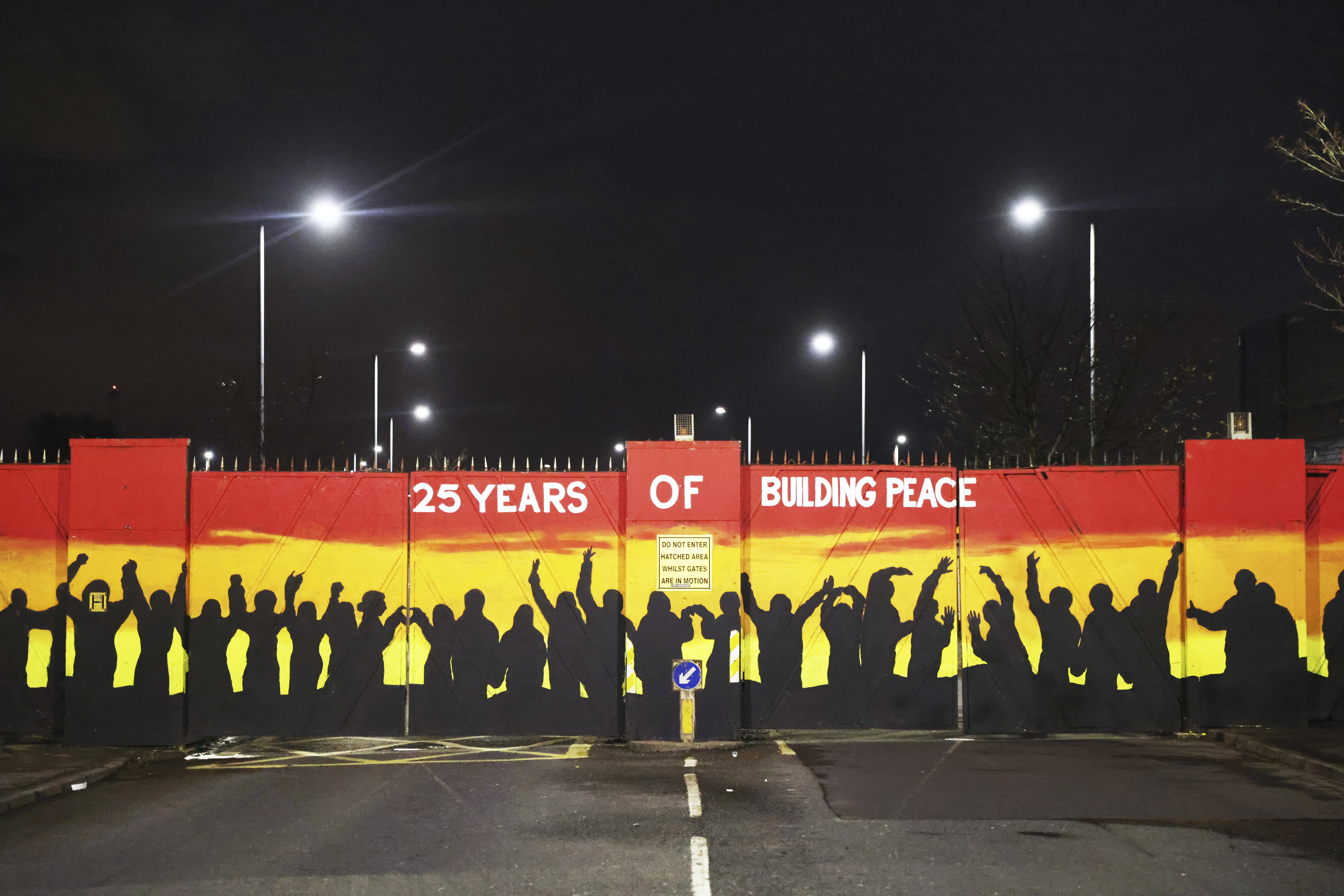 A mural on the peace gates at Lanark Way celebrates the Good Friday Agreement, in west Belfast, on April 5, 2023 [Peter Morrison/AP]
