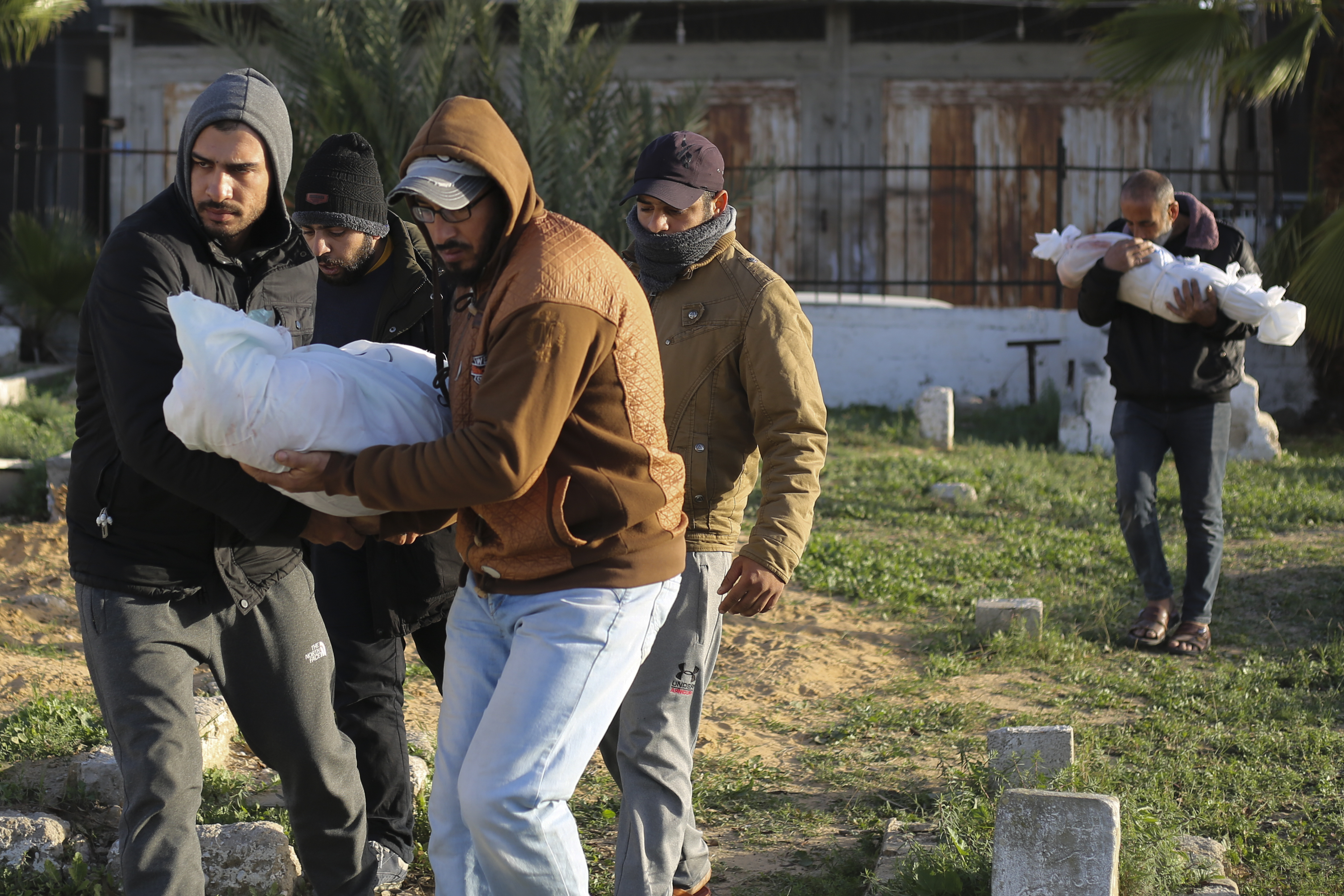 Palestinians carry the bodies of the Dhair family, killed in the Israeli bombardment of the Gaza Strip, during their funeral in Rafah on Friday, Dec. 22, 2023.