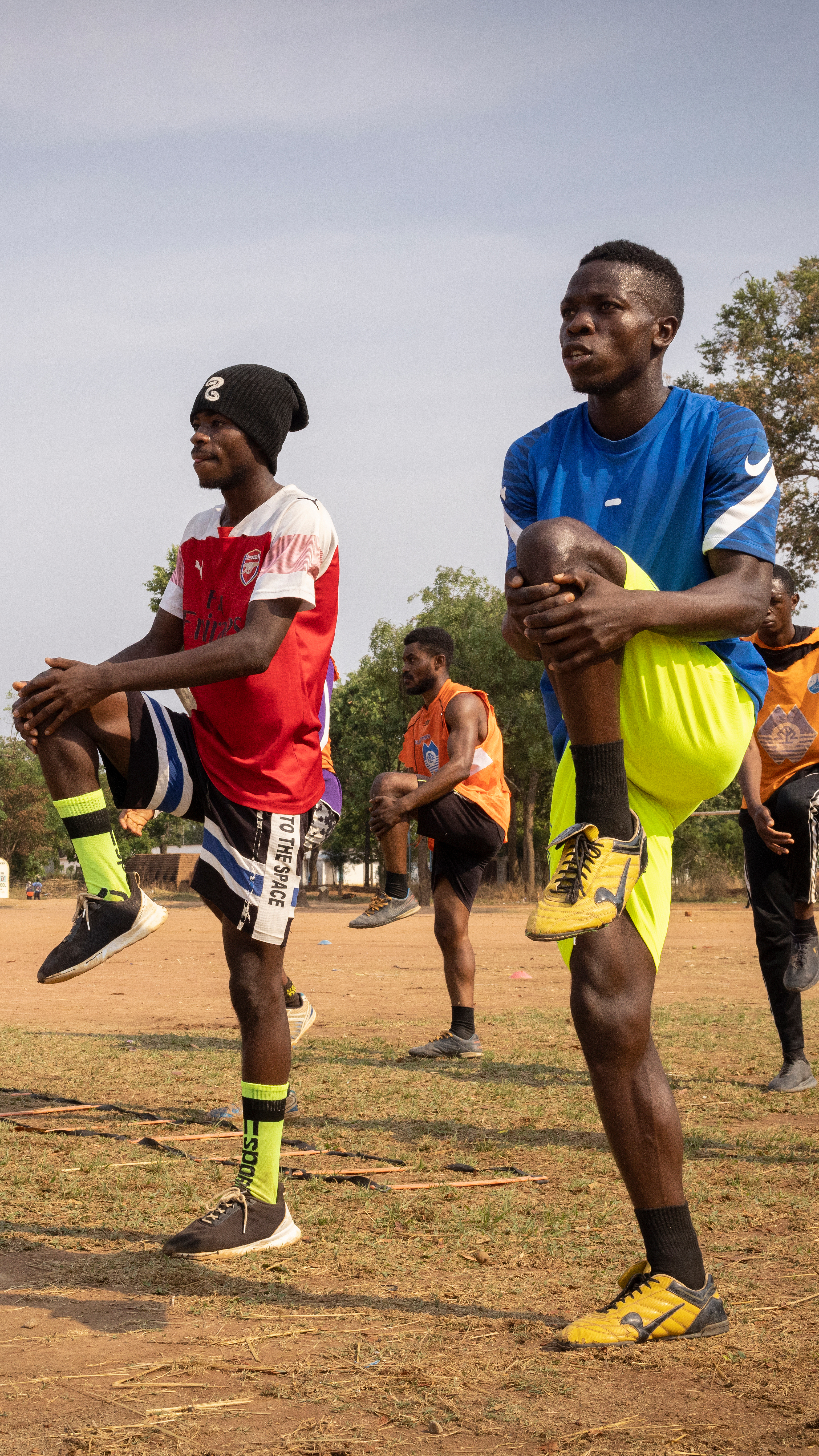 Footballers train on a pitch in Zambia