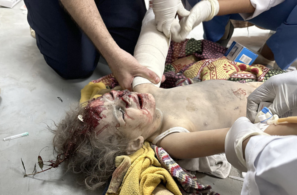 Doctors examine injured people including children, brought to at Al-Aqsa Martyrs Hospital following the Israeli attack on Al-Maghazi refugee camp in Deir al-Balah, Gaza.