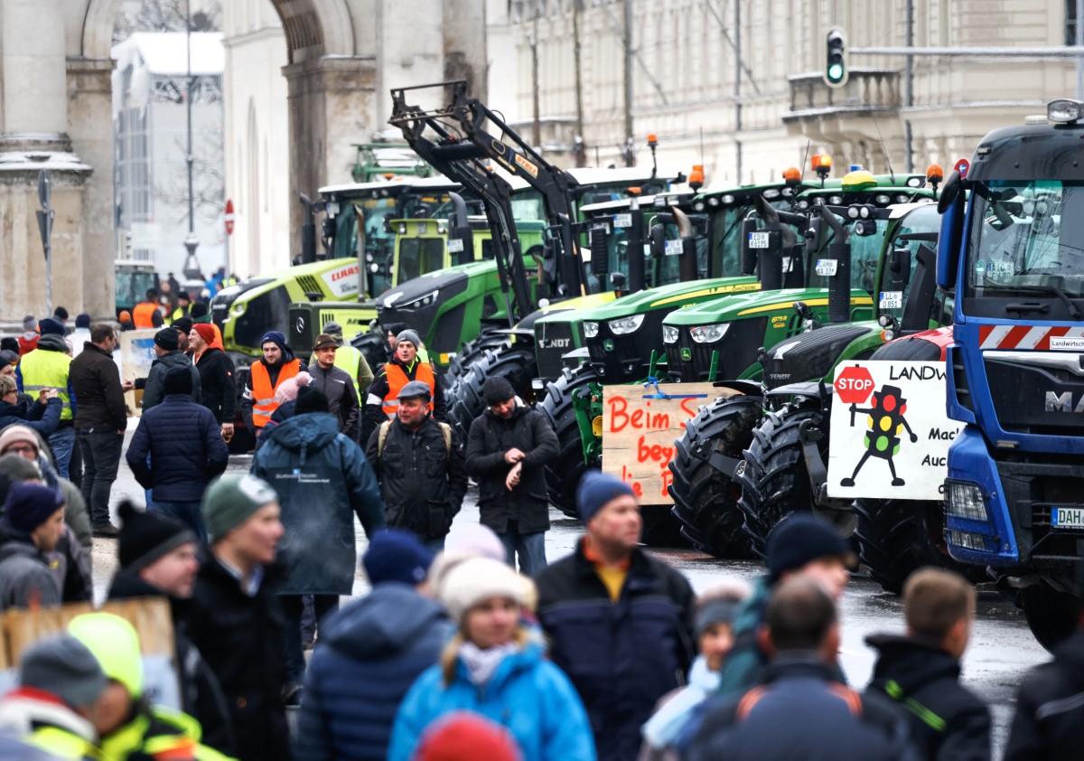 Farmers with their tractors stand at Odeonsplatz square in the city center to take part in protests against the federal government's austerity plans in Munich
