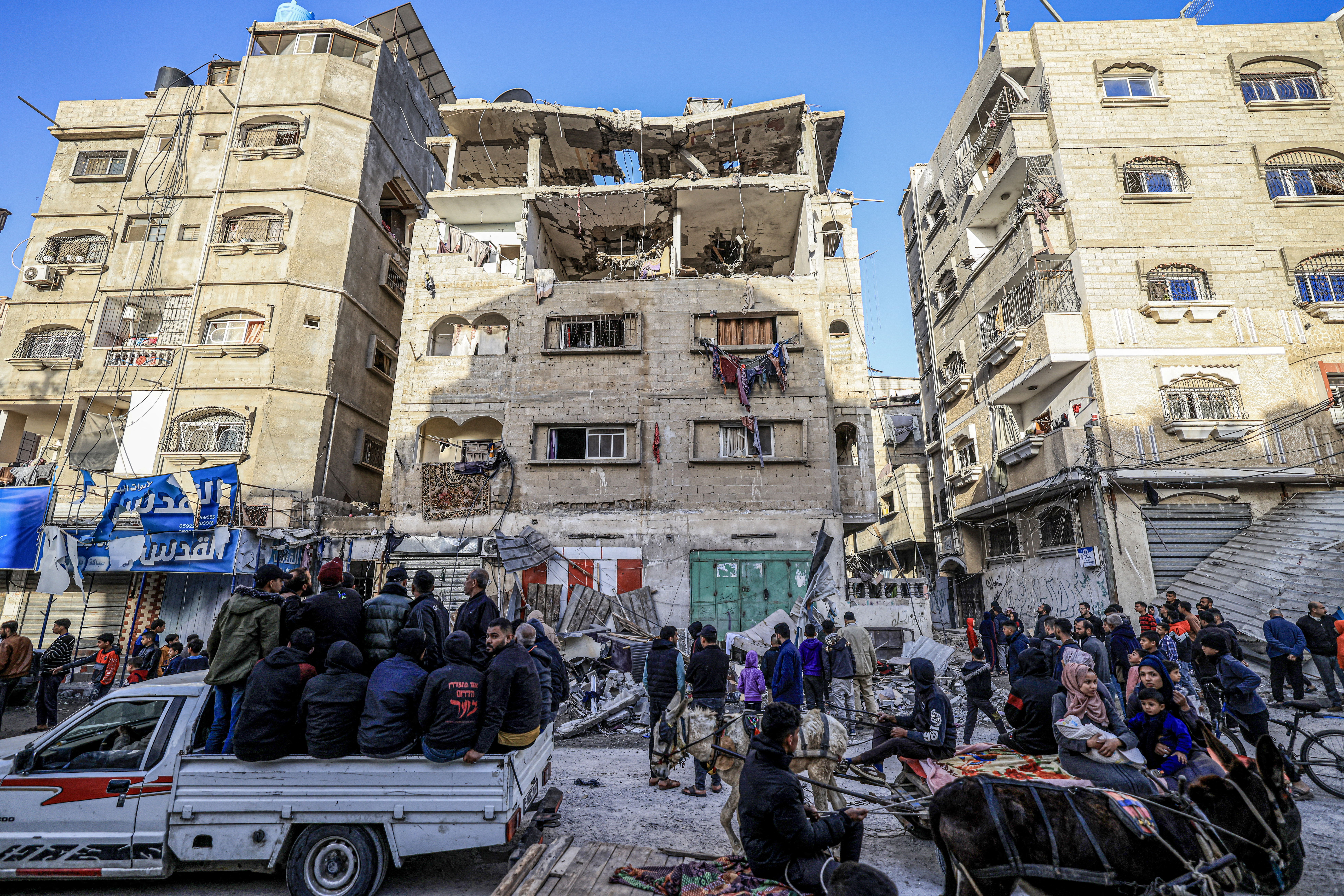 People check the damages to the house of the Palestinian Nofal family