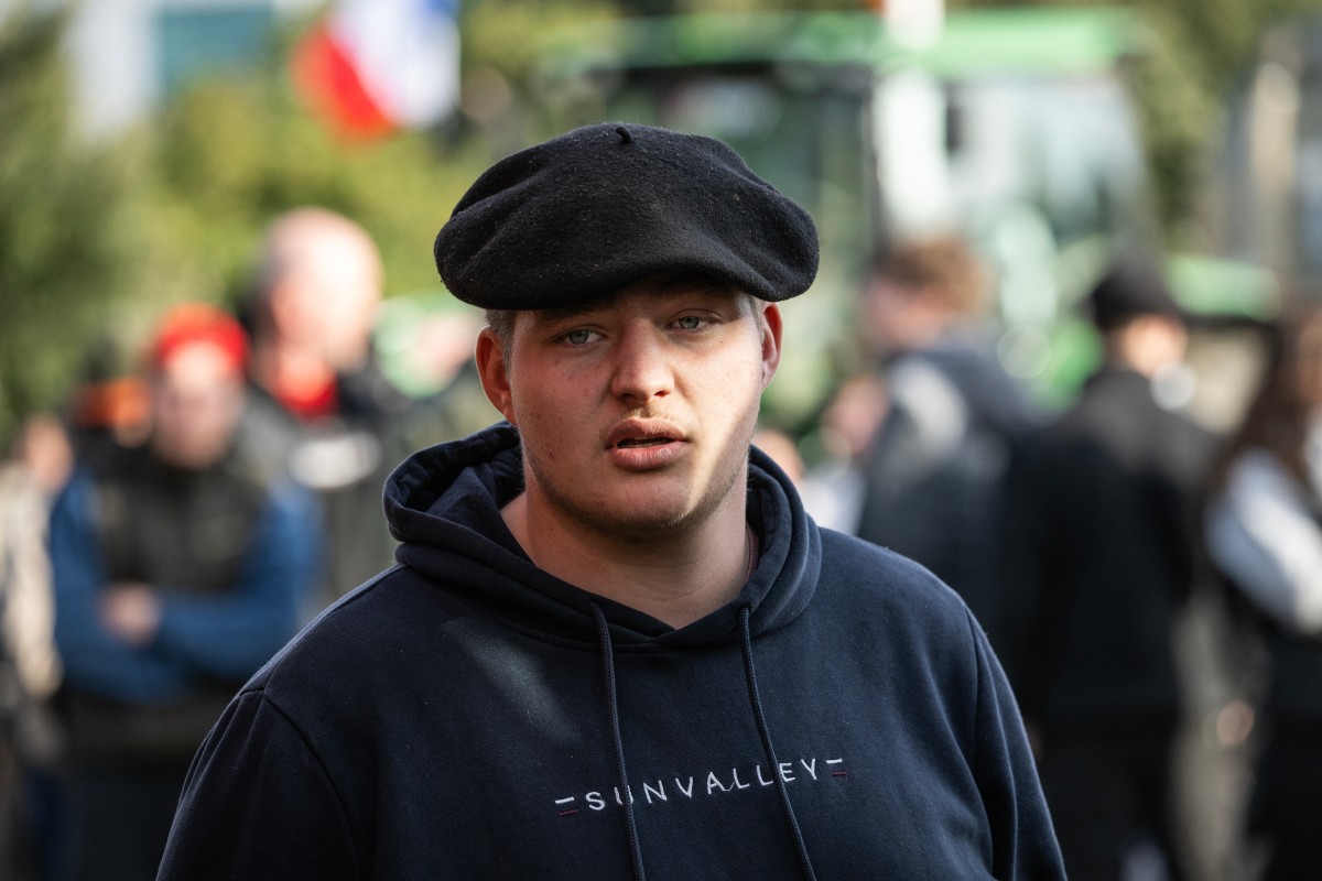 Farmers drive their tractors during a protest
