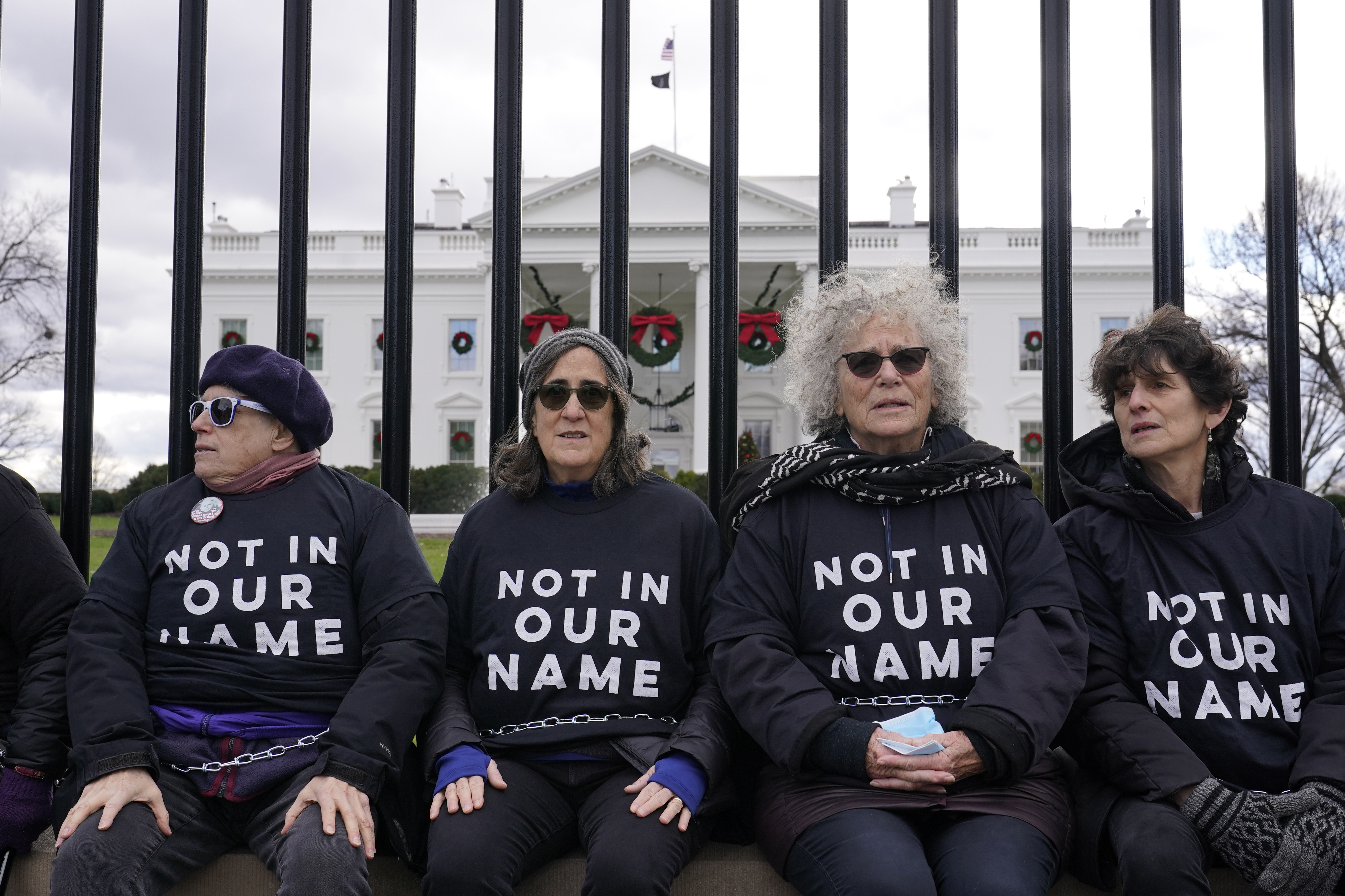 Activists with Jewish Voice for Peace, gather to protest the Israel-Hamas war in Gaza and chain themselves to the fence outside the White House, Monday, Dec. 11, 2023, in Washington. (AP Photo/Susan Walsh)