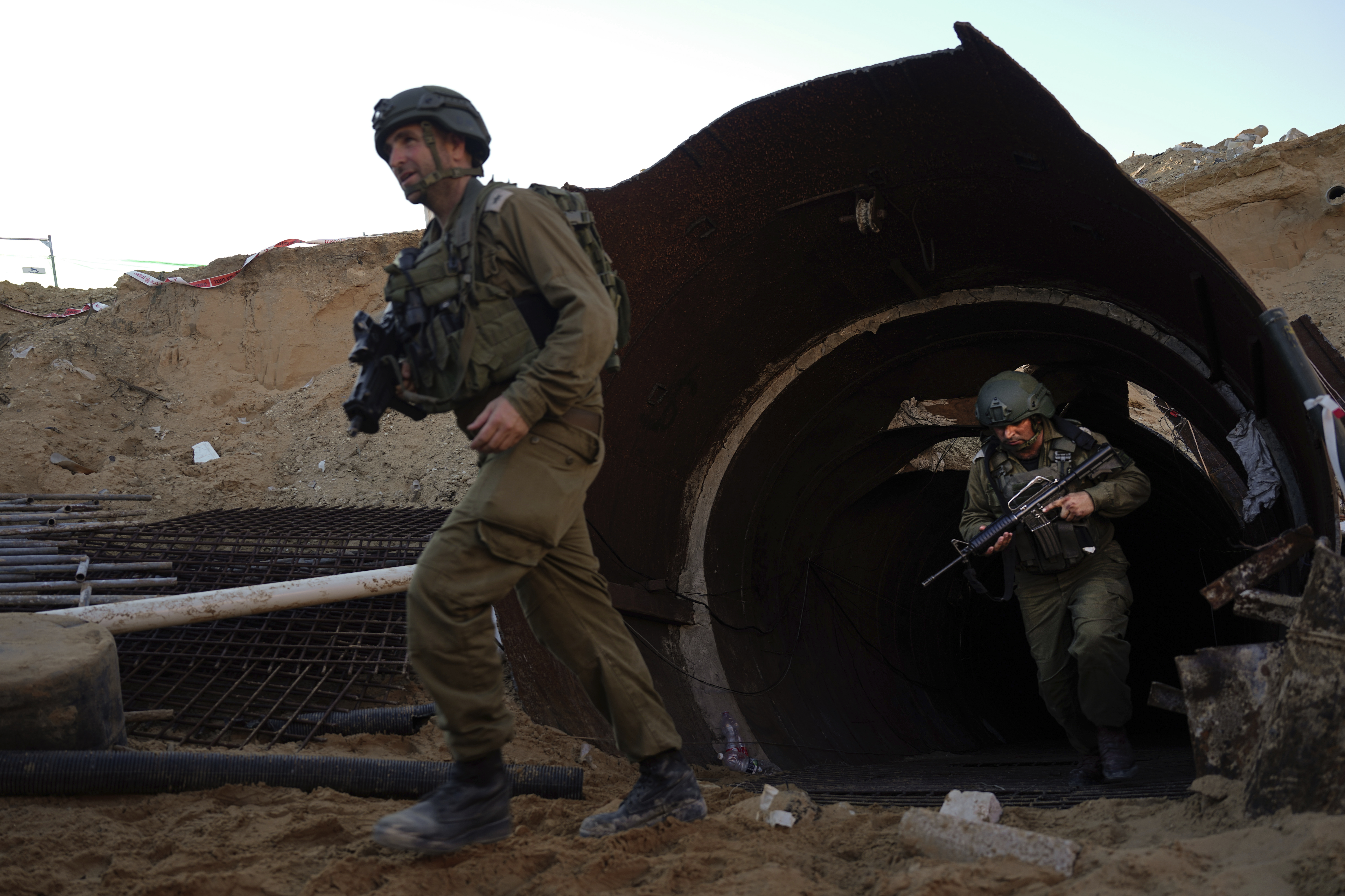Israeli soldiers exit a tunnel that the military says Hamas militants used to attack the Erez crossing in the northern Gaza Strip, Friday, Dec. 15, 2023. The army is battling Palestinian militants across Gaza to retaliate for Hamas' Oct. 7 attack on Israel. (AP Photo/Ariel Schalit)