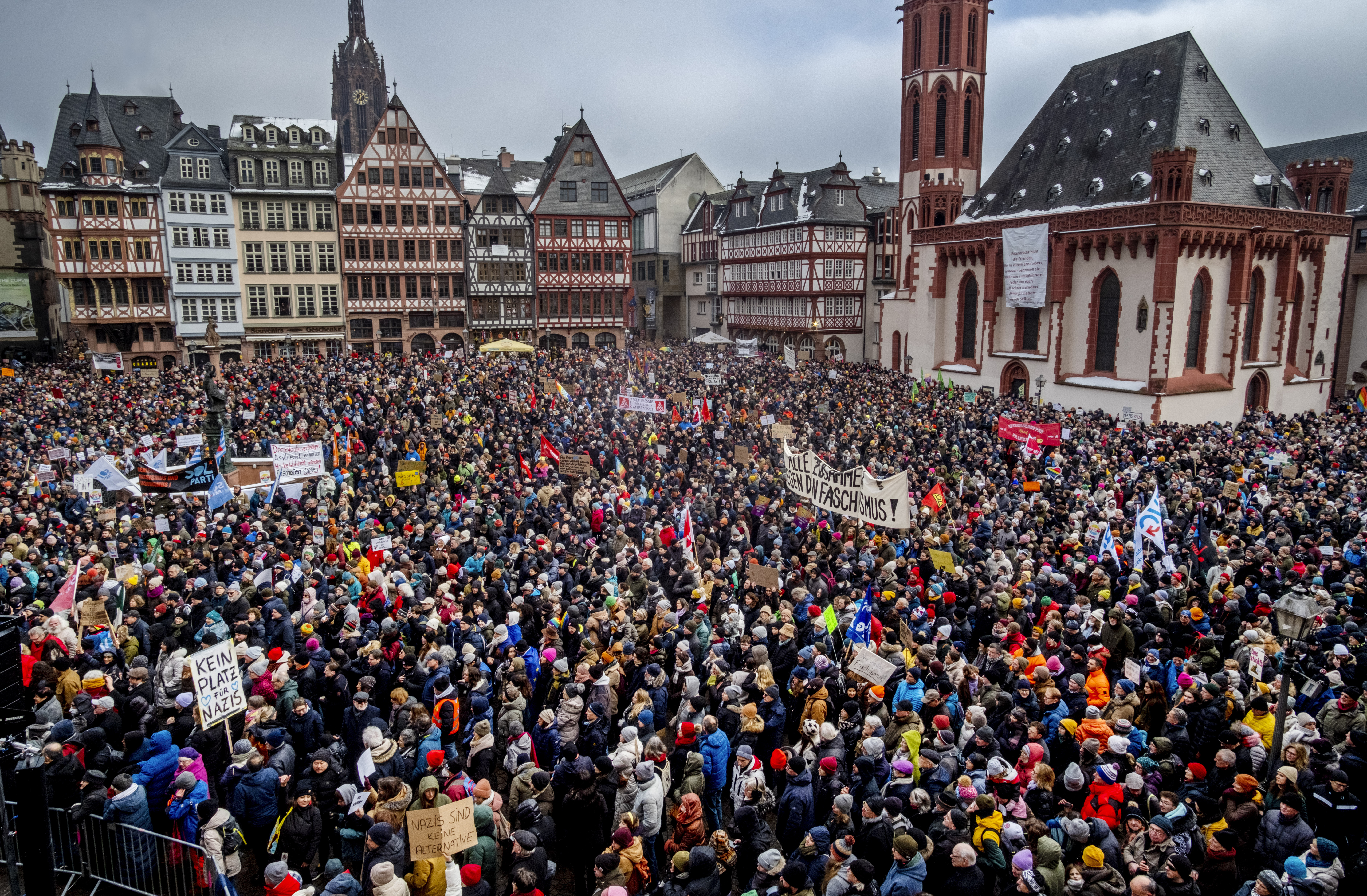People gather as they protest against the AfD party and right-wing extremism in Frankfurt/Main, Germany, Saturday, Jan. 20