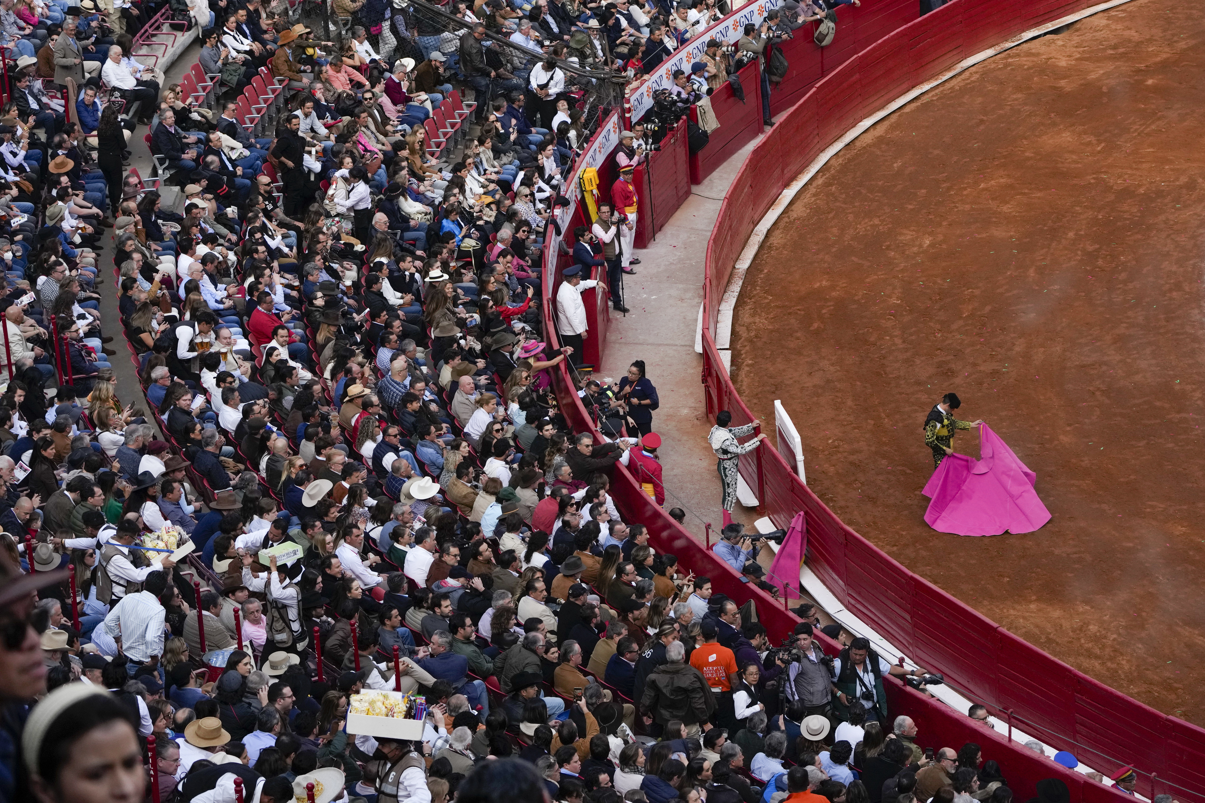 Spectators watch a bullfight at the Plaza Mexico,
