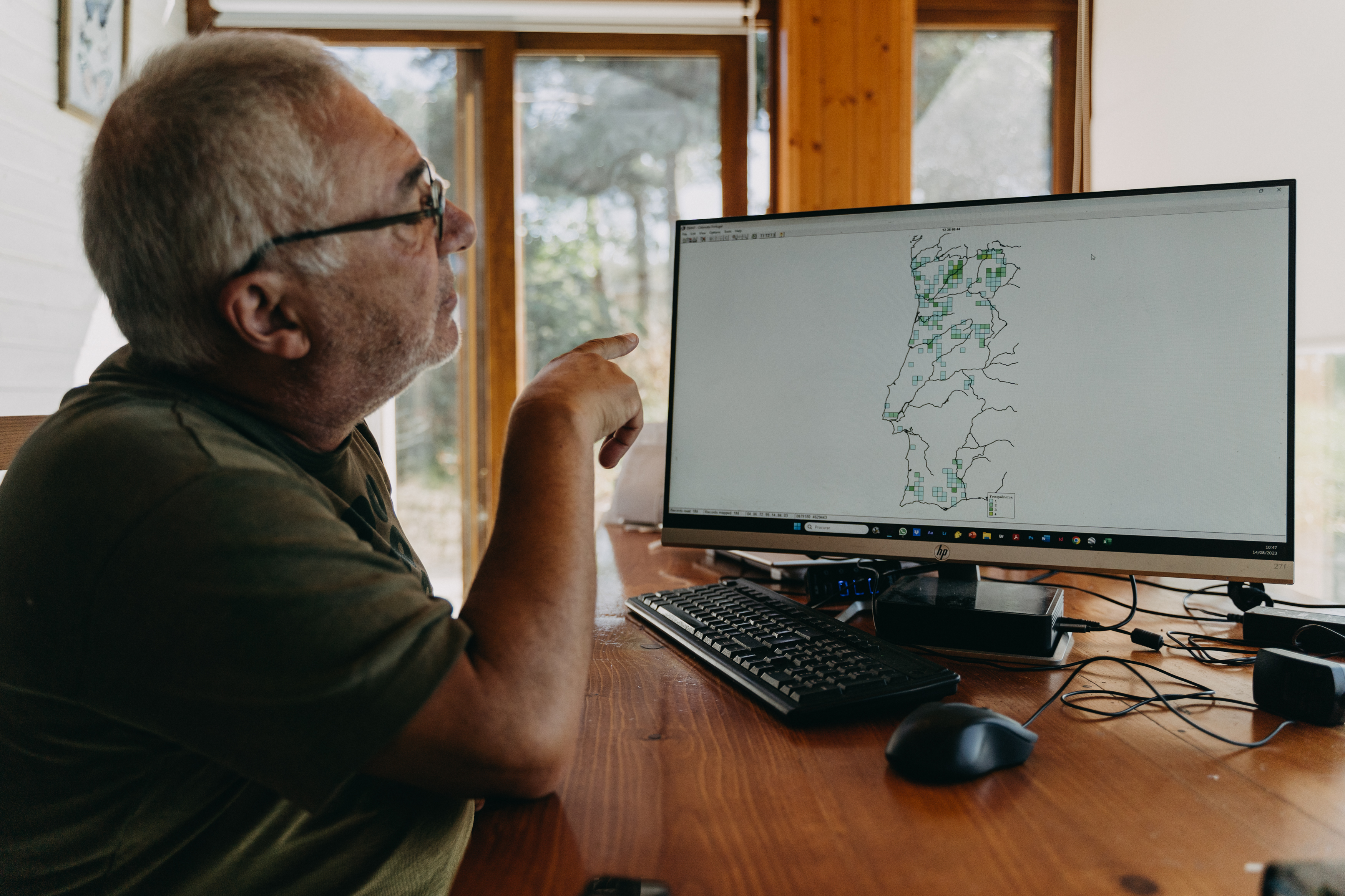 Butterfly expert Ernestino Maravalhas shows a map of species frequency, in Beça, Portugal on 14 August 2023.