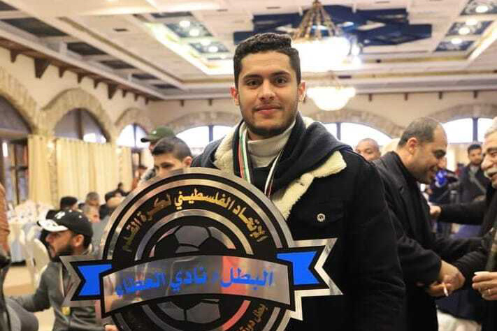 Khalid Abu-Habel with the Gaza third-tier championship trophy that he won with his club Al-Ataa in January 2023 [Courtesy Khalid Abu-Habel]