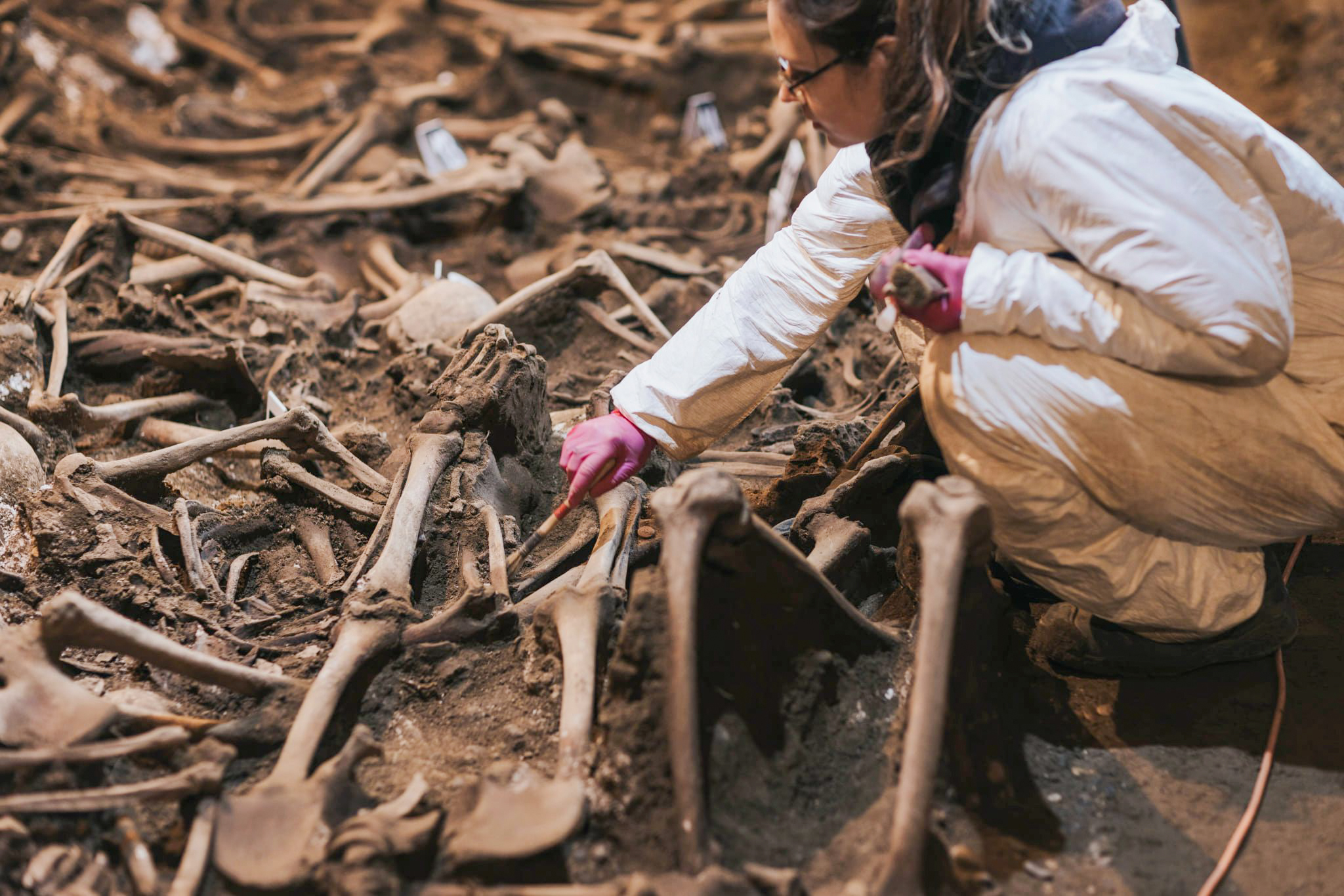 A forensic expert excavates a mass grave in Georgia