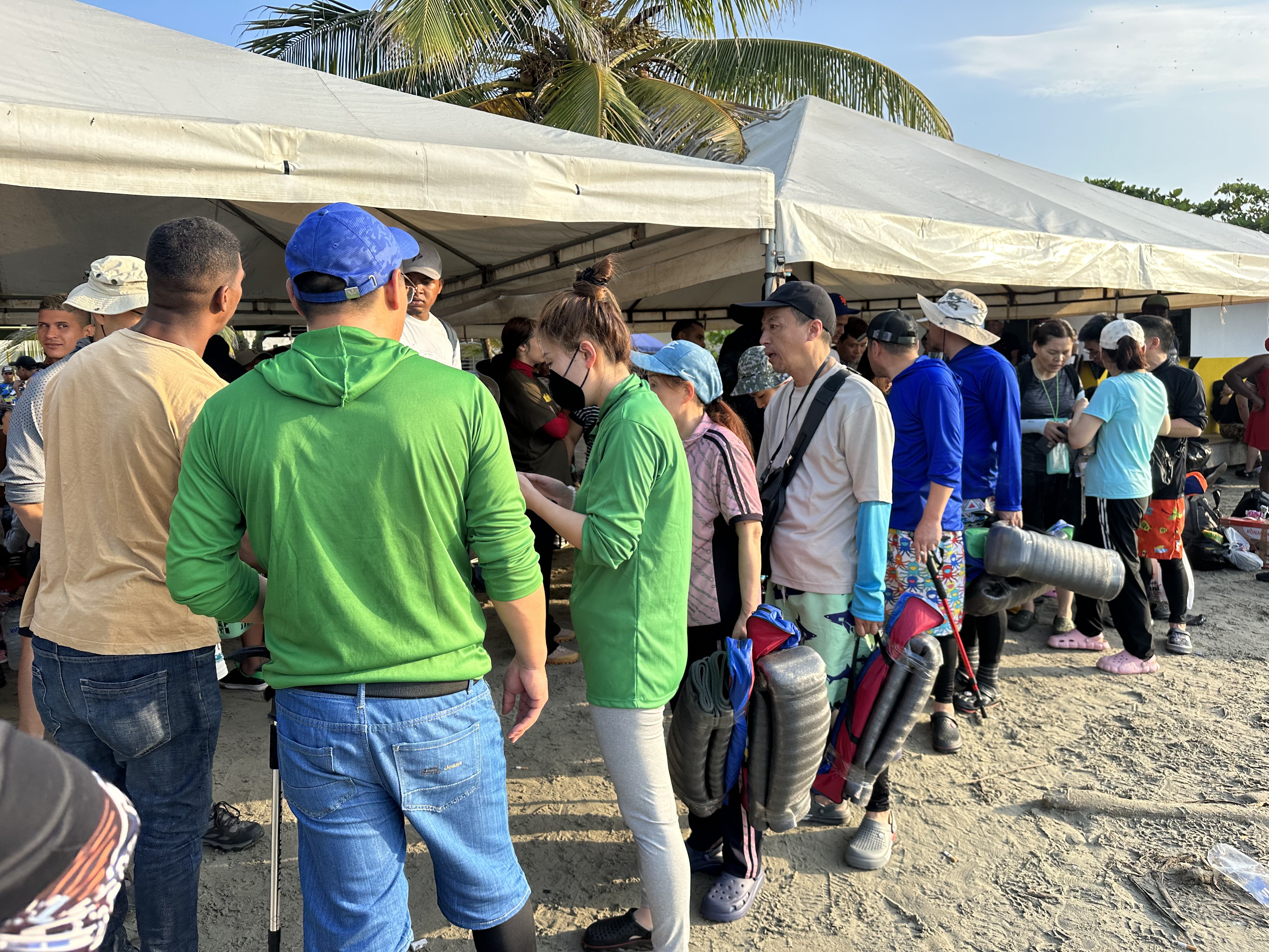 A line of Chinese migrants waiting to depart on boats in Necoclí-