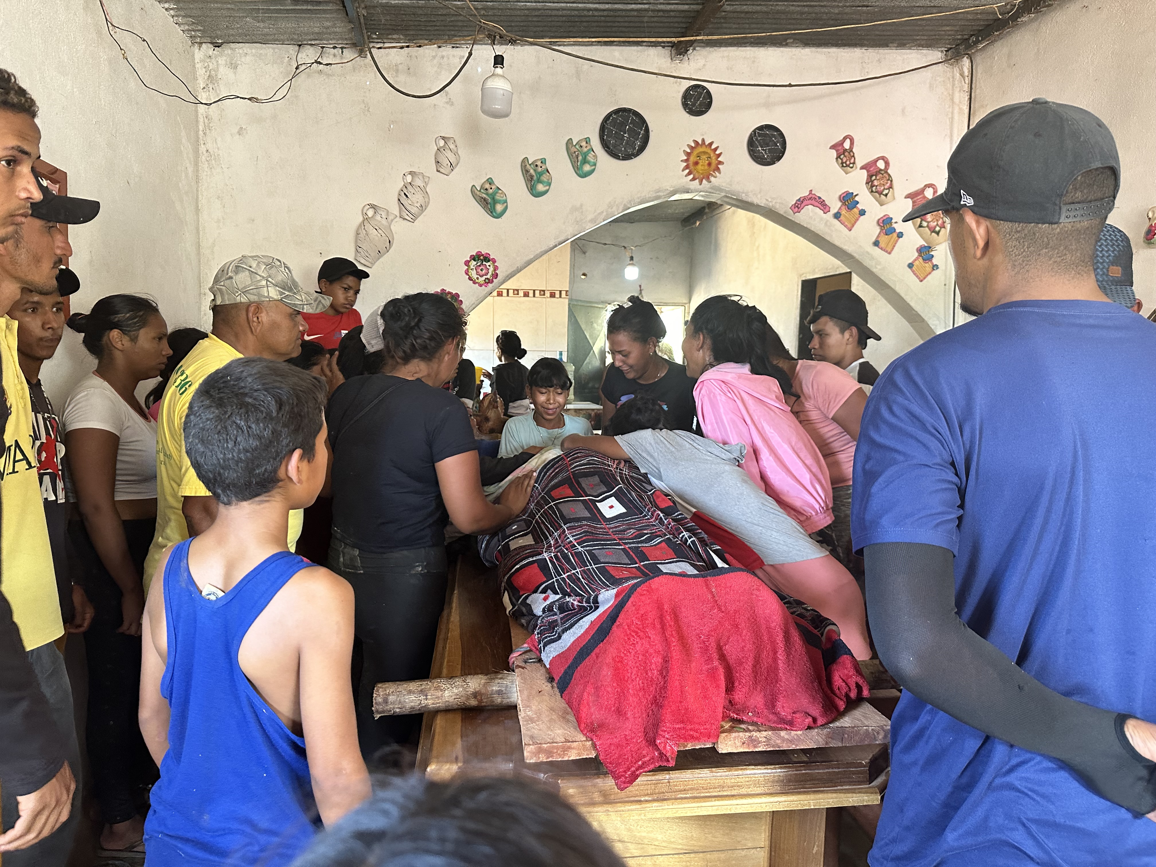 Relatives mourn one of the miners that died after the collapse of a remote illegal mine, in La Paragua, Bolivar state