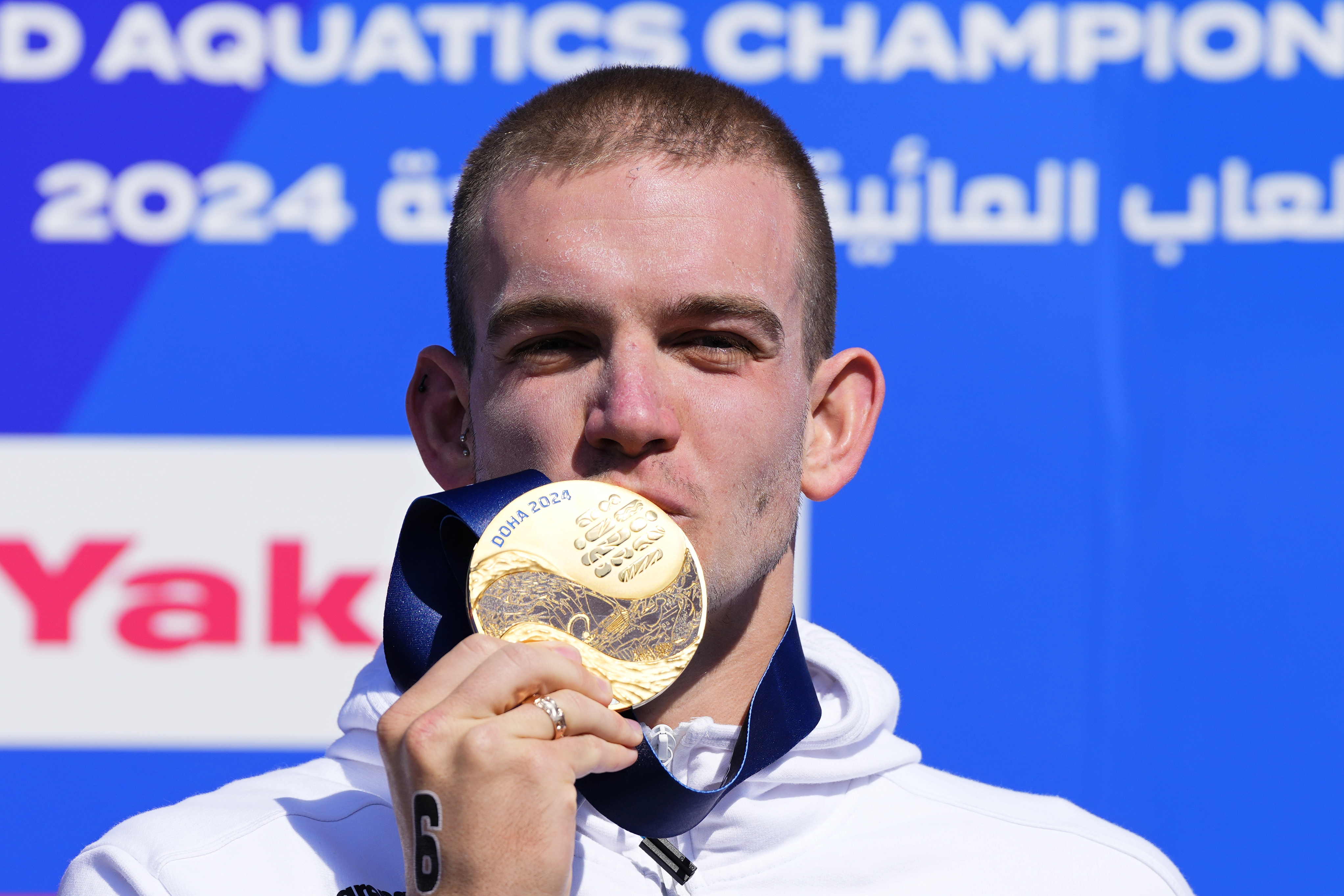 Kristof Rasovszky of Hungary poses on the podium after winning the men's 10 km open water final at the World Aquatics Championships in Doha, Qatar, Sunday, Feb. 4