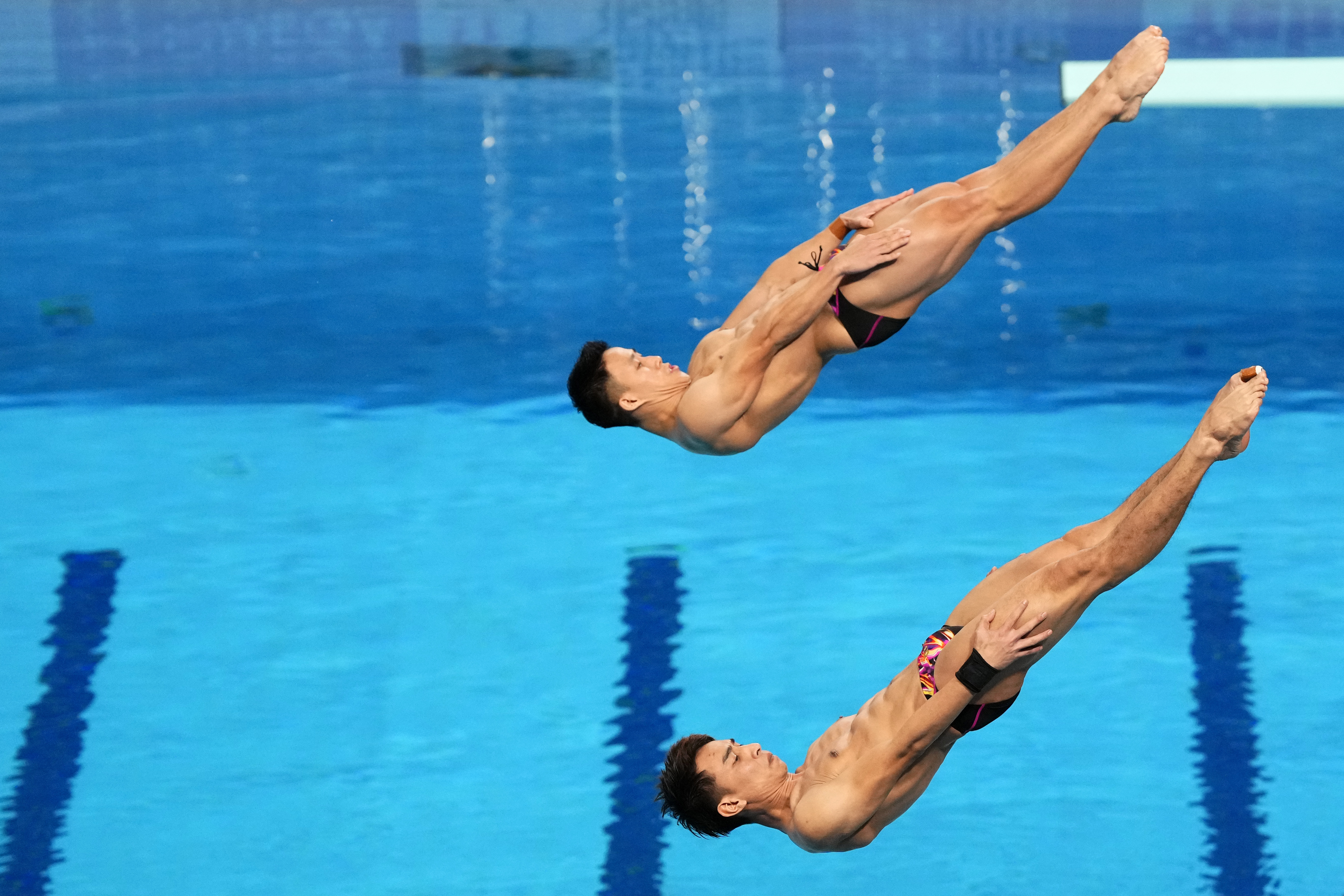 Tze Liang Ooi and Muhammad Syafiq Puteh of Malasyia compete during the men's 3 m synchronised diving final at the World Aquatics Championships in Doha, Qatar, Sunday, Feb. 4