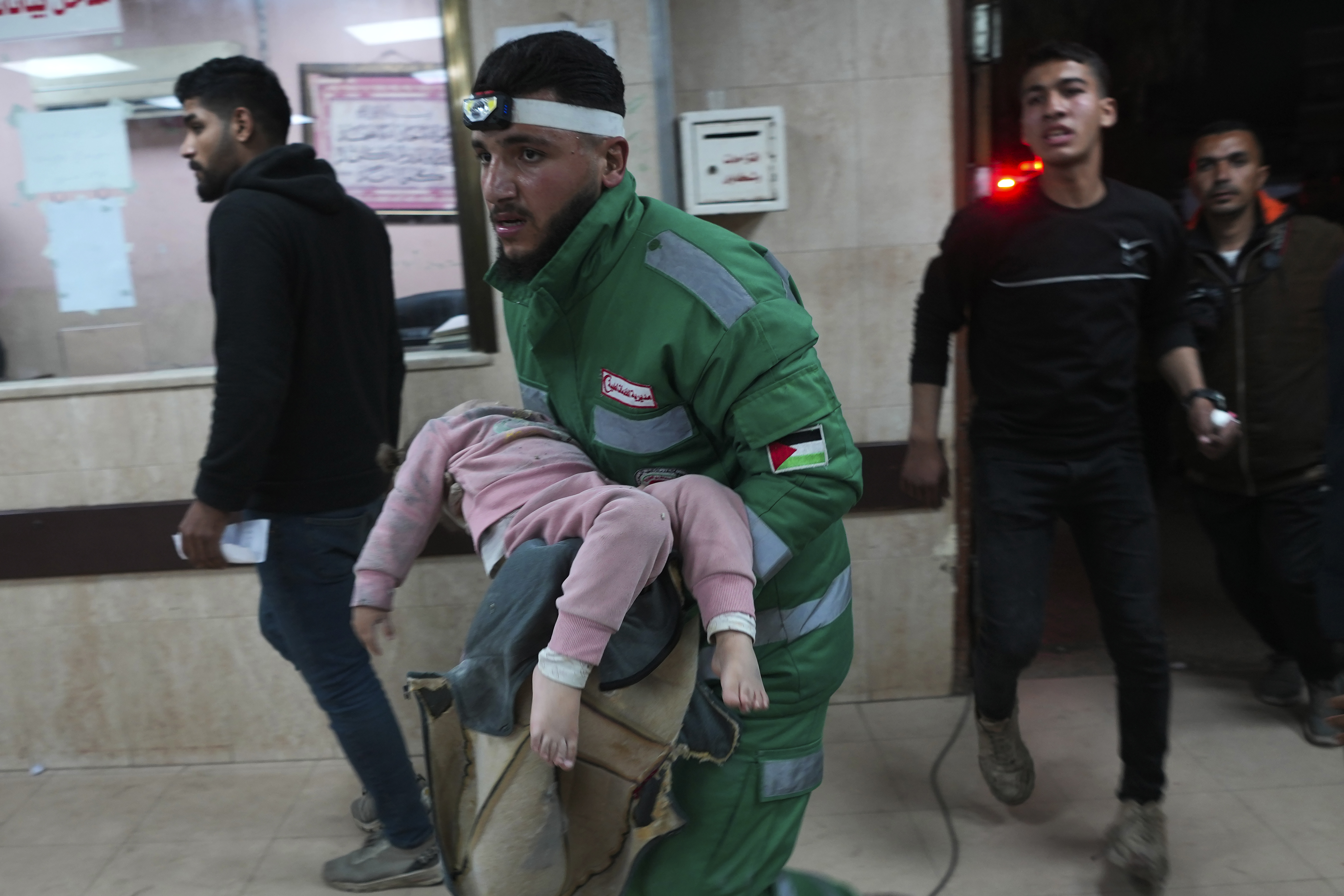 Palestinians wounded in the Israeli bombardment of the Gaza Strip are brought to Al Aqsa hospital in Deir al Balah, Friday, Feb. 23