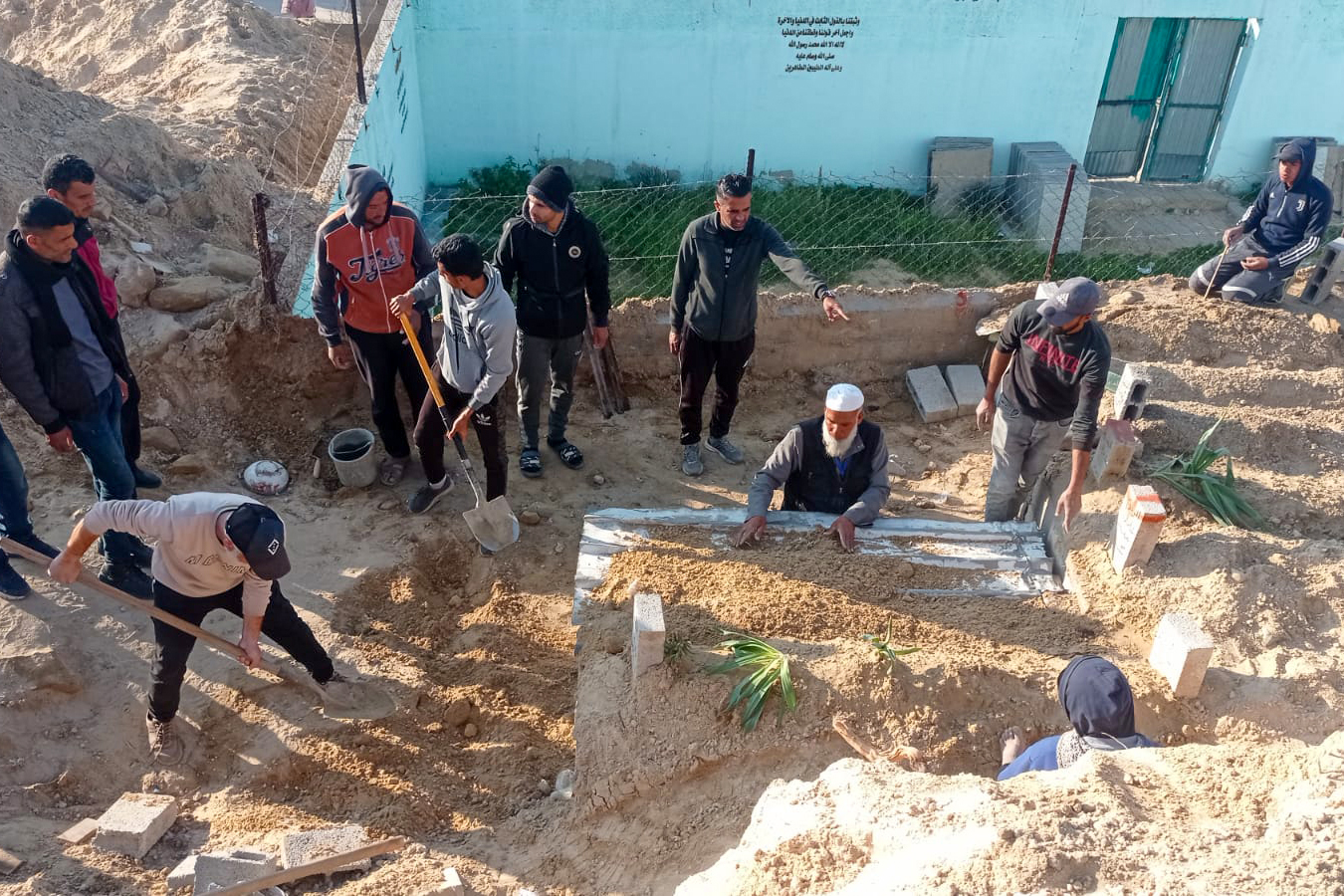 Abu-Jawad doing his burial duties with his men-