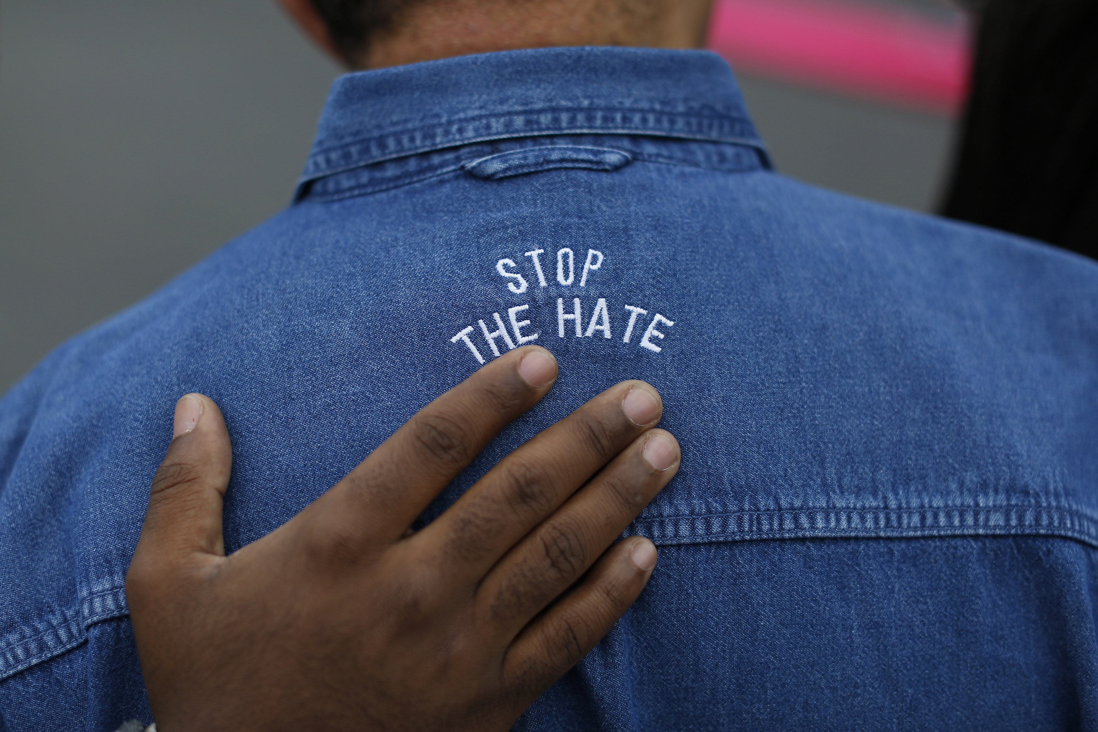 A protester is seen with the words 'Stop the hate' on his shirt