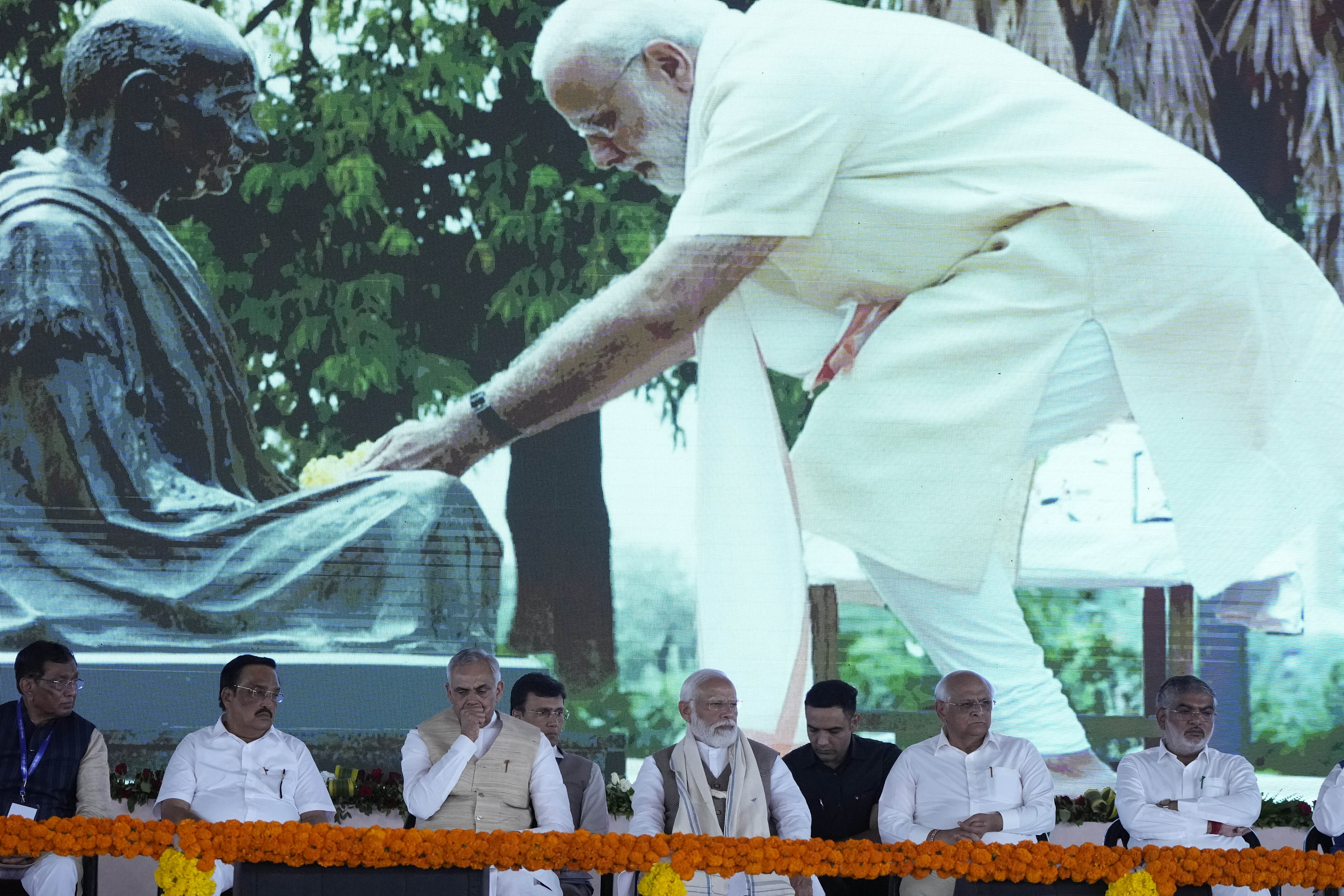 Indian Prime Minister Narendra Modi, center, sits during the launch of the redevelopment project of the Sabarmati Mahatma Gandhi Ashram in Ahmedabad, India, Tuesday, March 12, 2024. (AP Photo/Ajit Solanki)