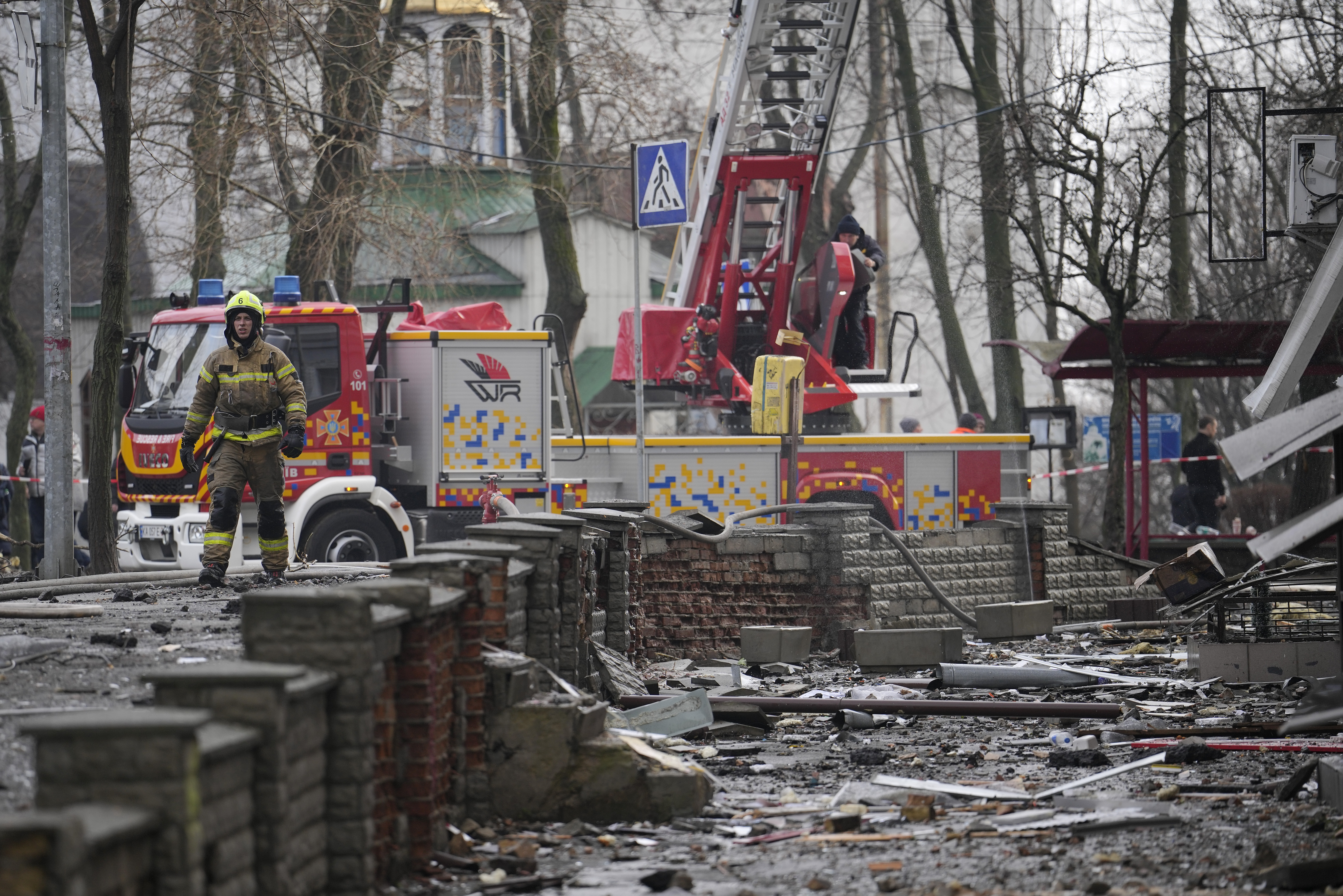 A firefighter walks amongst the debris after a Russian attack in Kyiv