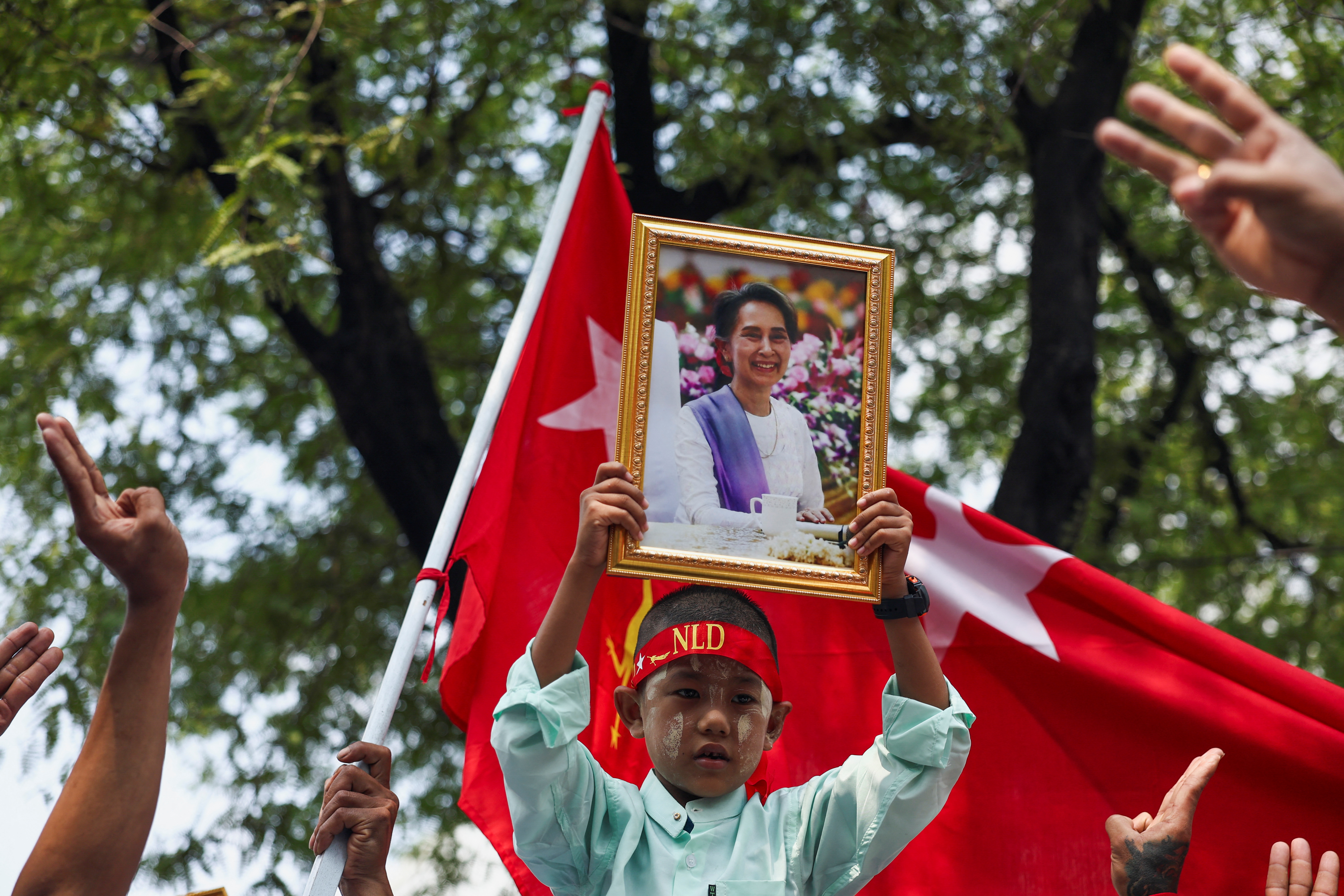 A protester holds up a portrait of Aung San Suu Kyi during a demonstration to mark the third anniversary of Myanmar’s 2021 military coup, outside of the United Nations office in Bangkok, Thailand, February 1, 2024.