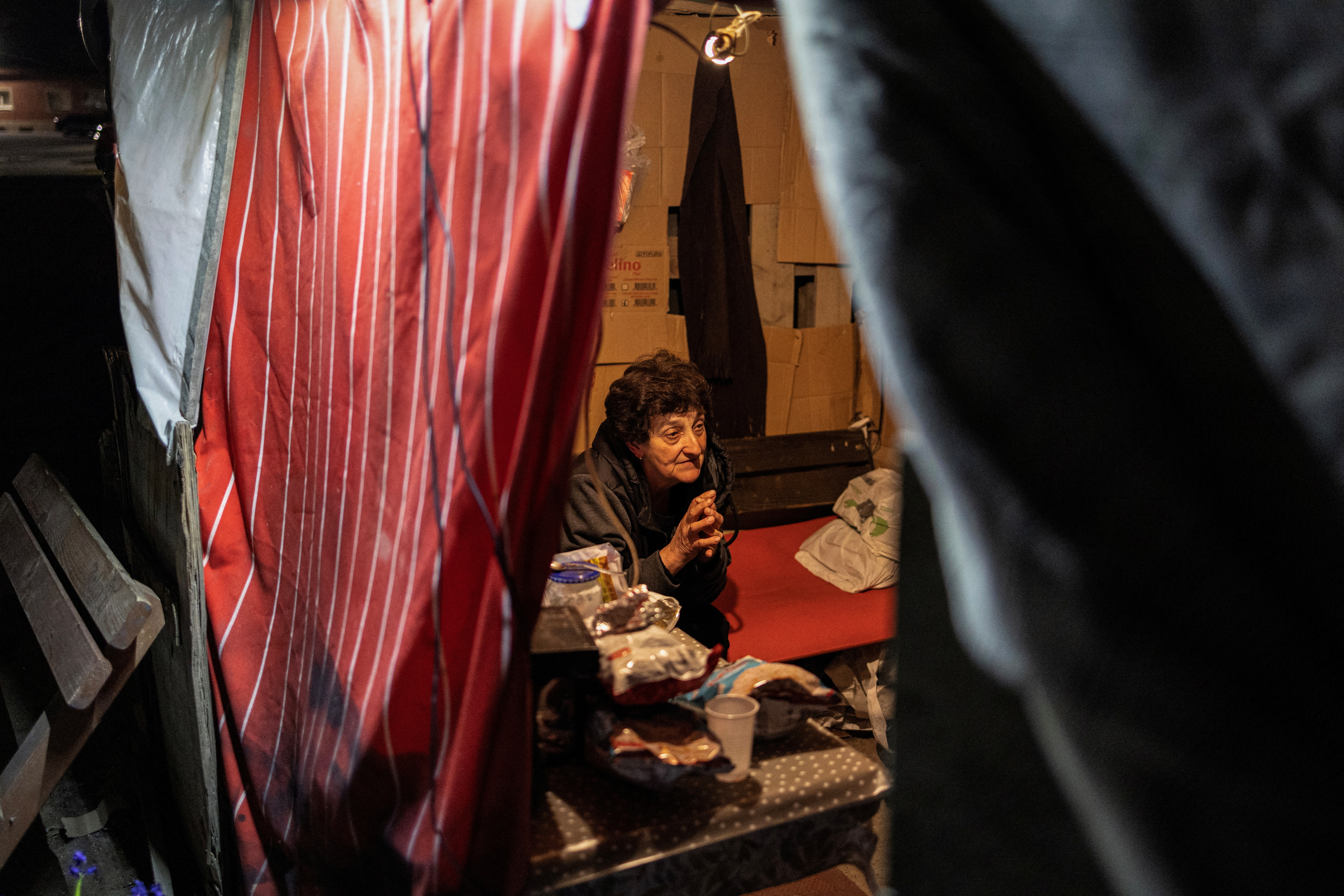 Debica Kostandinovic, 58, who is a housewife, sits at a road blockade in the village of Krivelj, Serbia, April 3