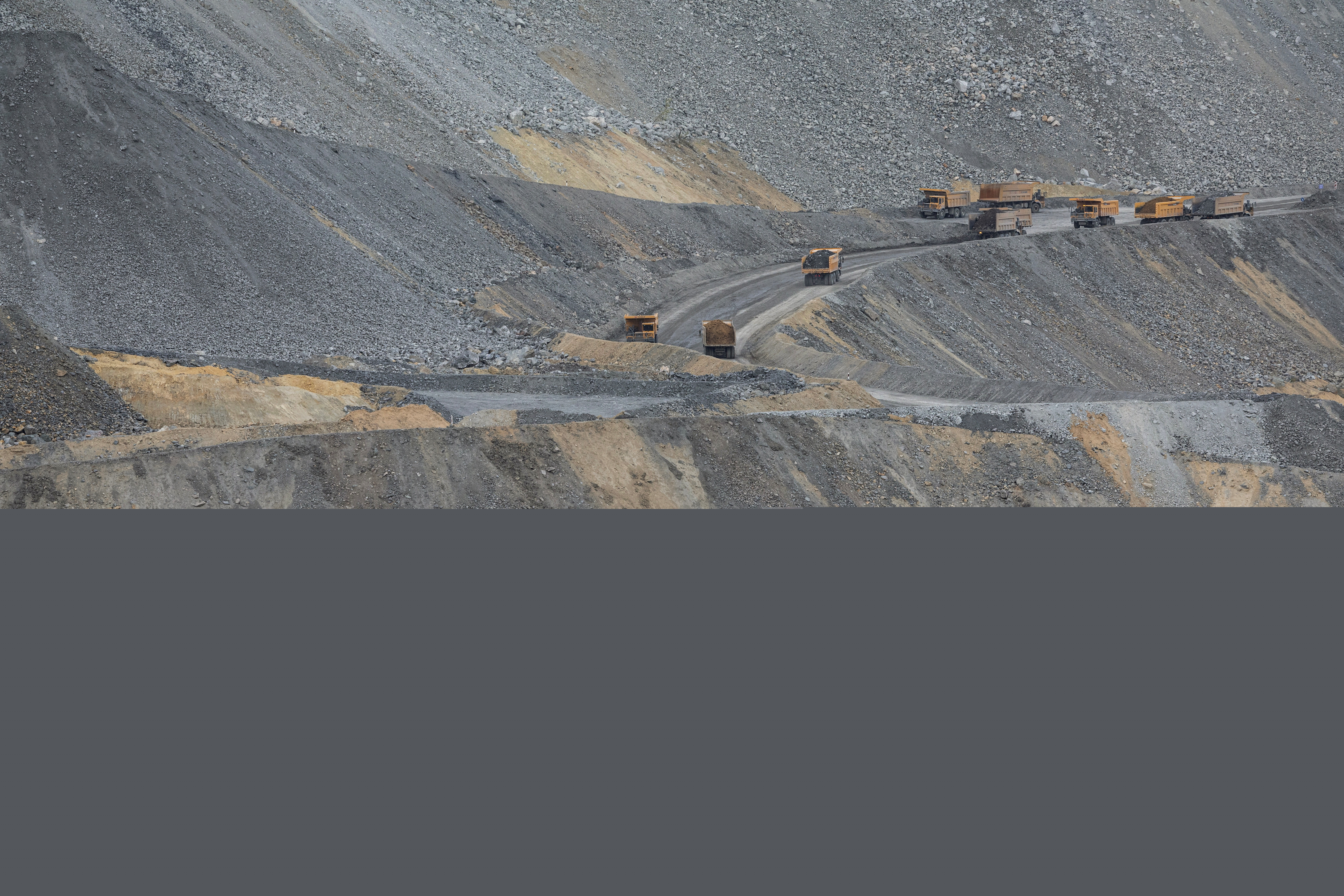 Trucks work at an open-pit copper mine, run by a subsidiary of China's Zijin Mining, near the village of Krivelj, Serbia, April 3