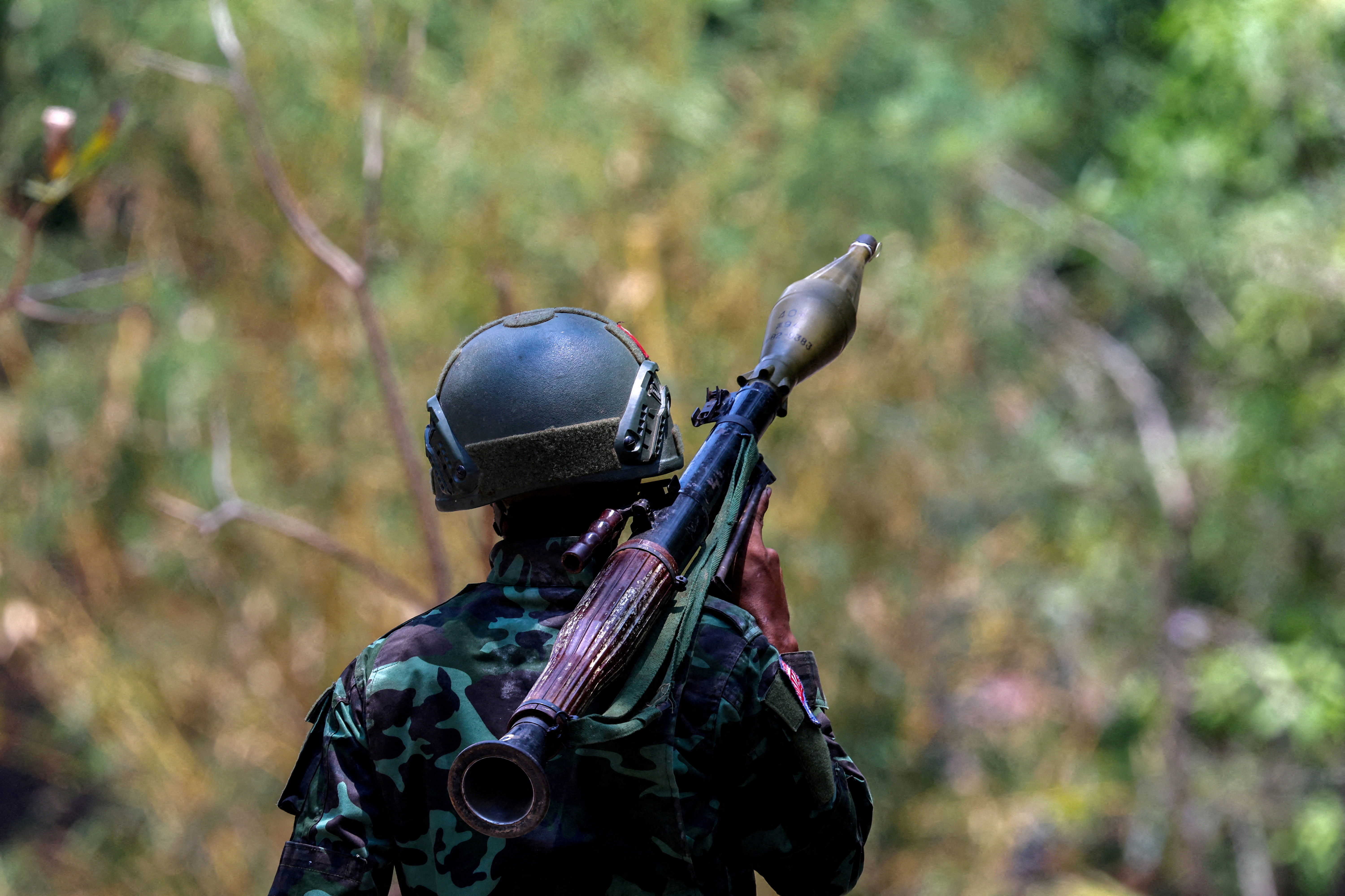 A soldier from the Karen National Liberation Army (KNLA) carries an RPG launcher