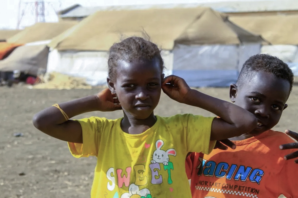 Displaced children who fled Khartoum and Gezira states playing near tents at a displacement camp in southern Gedaref State on March 20, 2024
