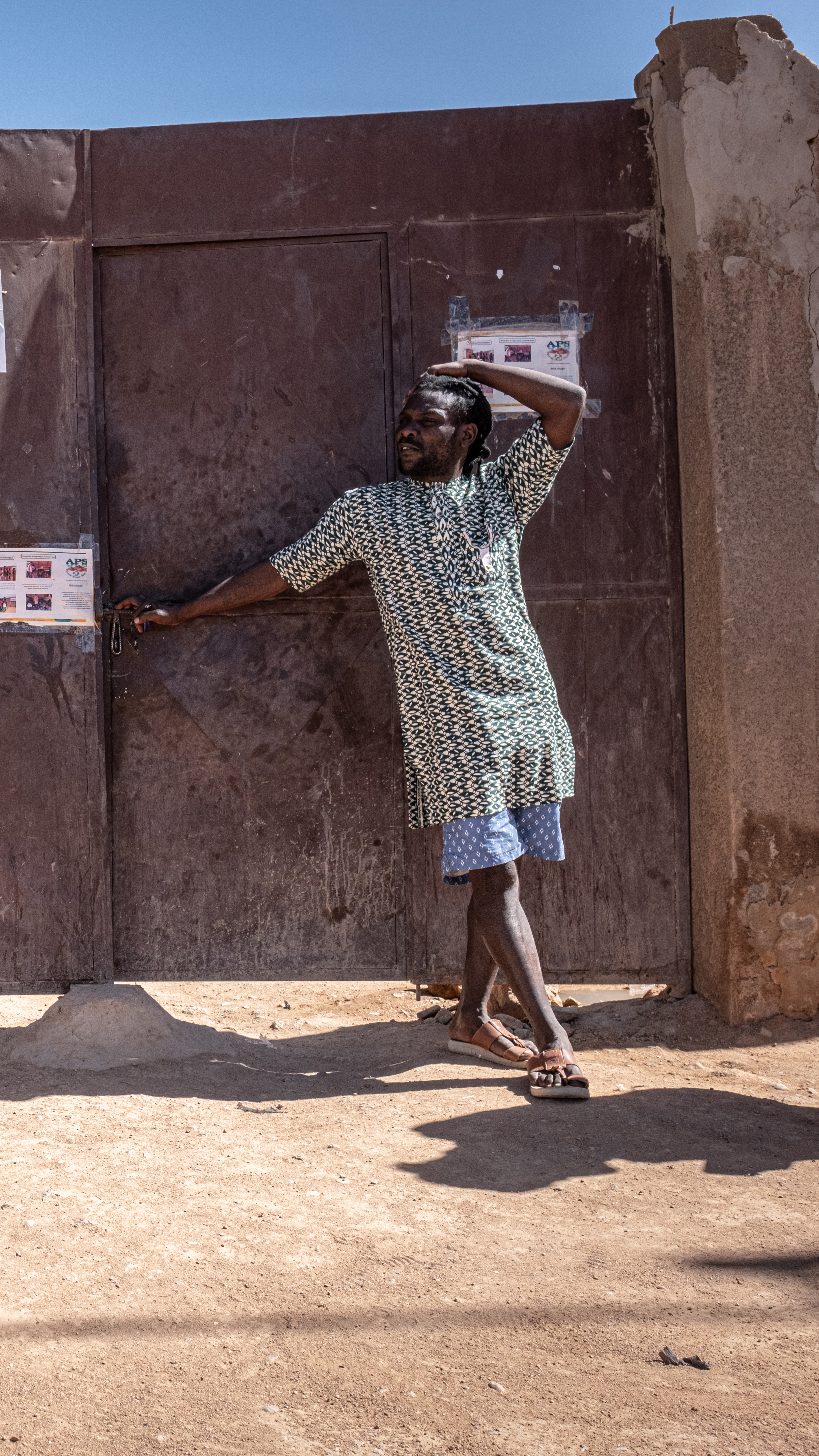 Khalifa Cisse, right, an Ivorian migrant, has been saving money to leave