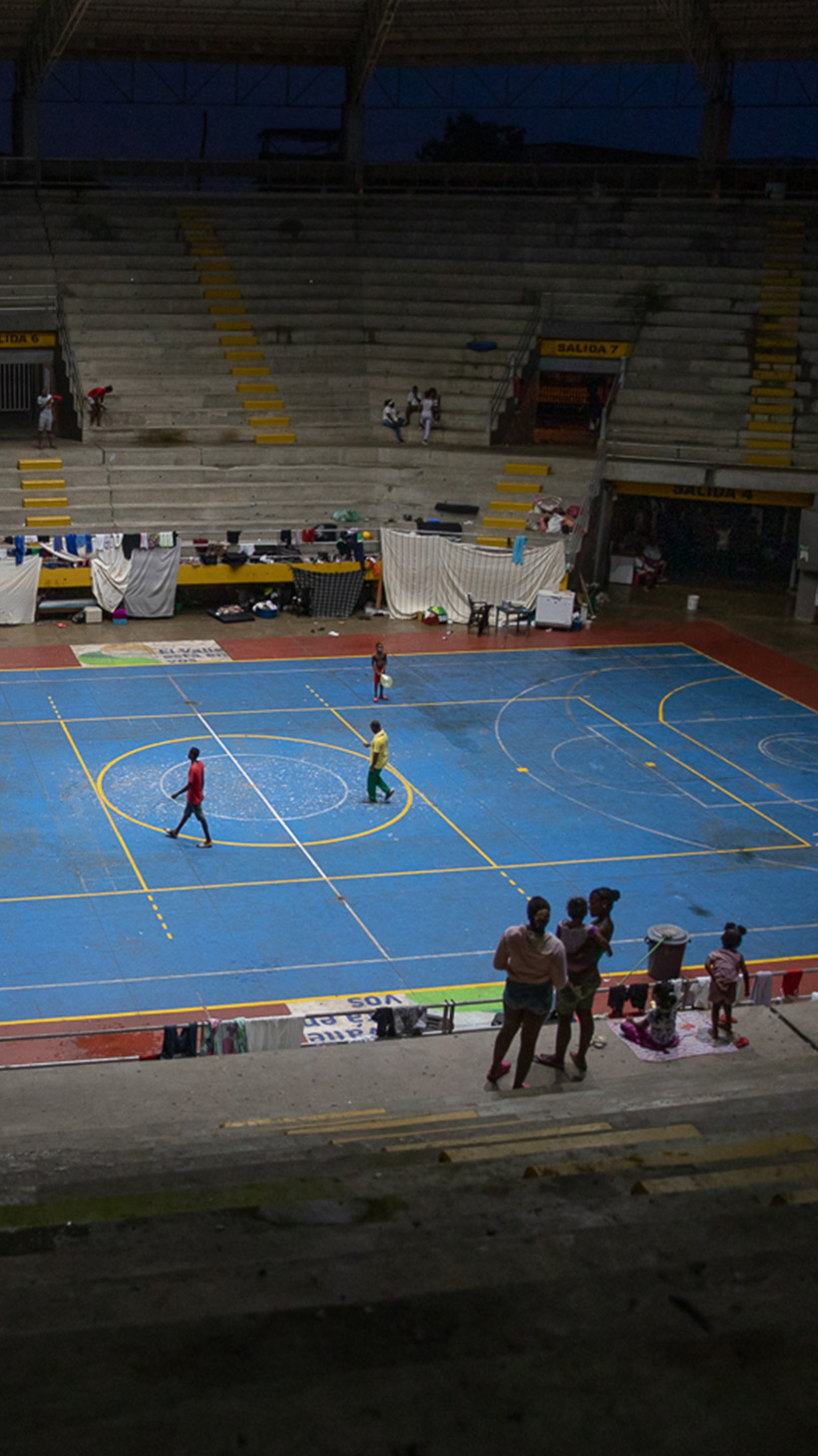 A view of the inside of Crystal Coliseum, with a blue basketball court surrounded by concrete stands