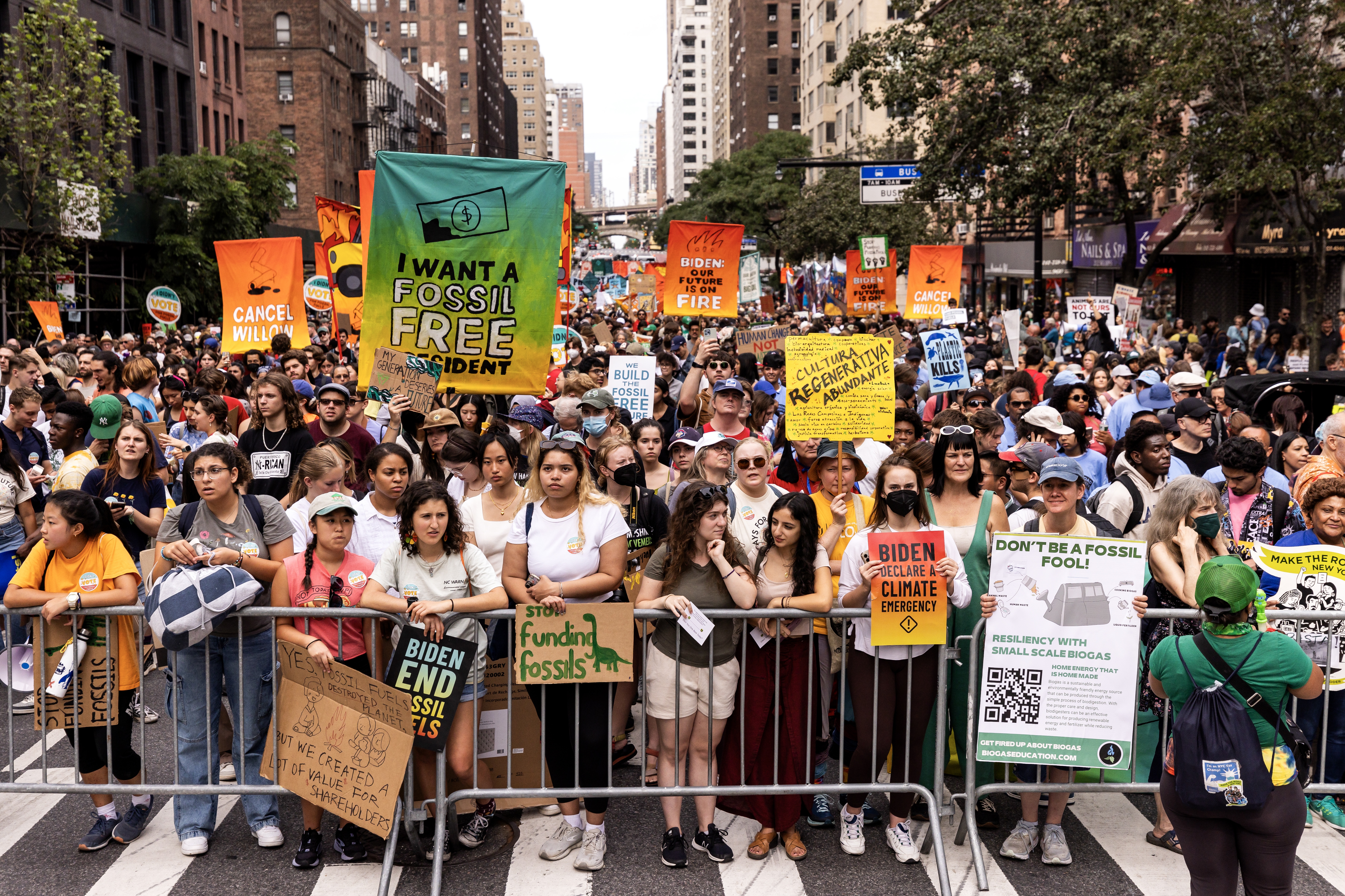 People display signs as they participate in the 'March to End Fossil Fuels' in NYC, US