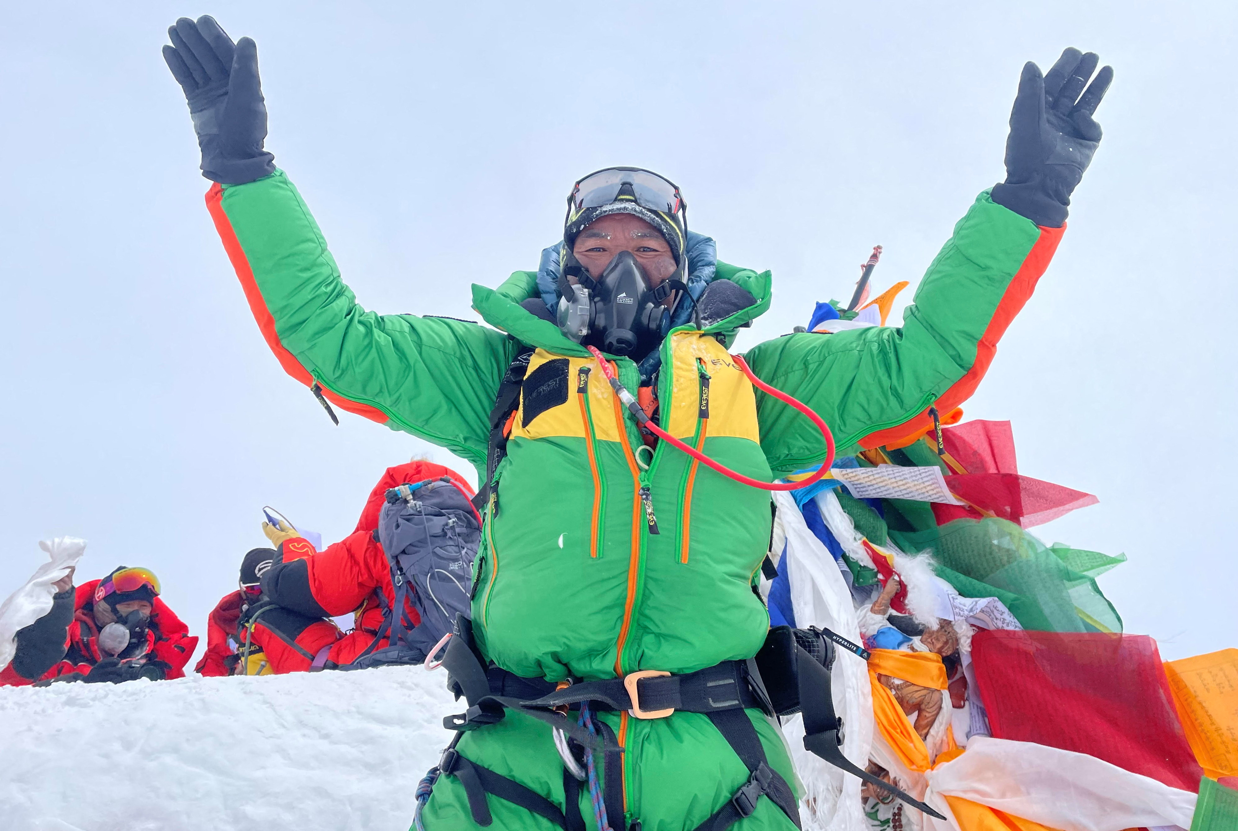 Kami Rita Sherpa is pictured on the summit of Mount Everest.