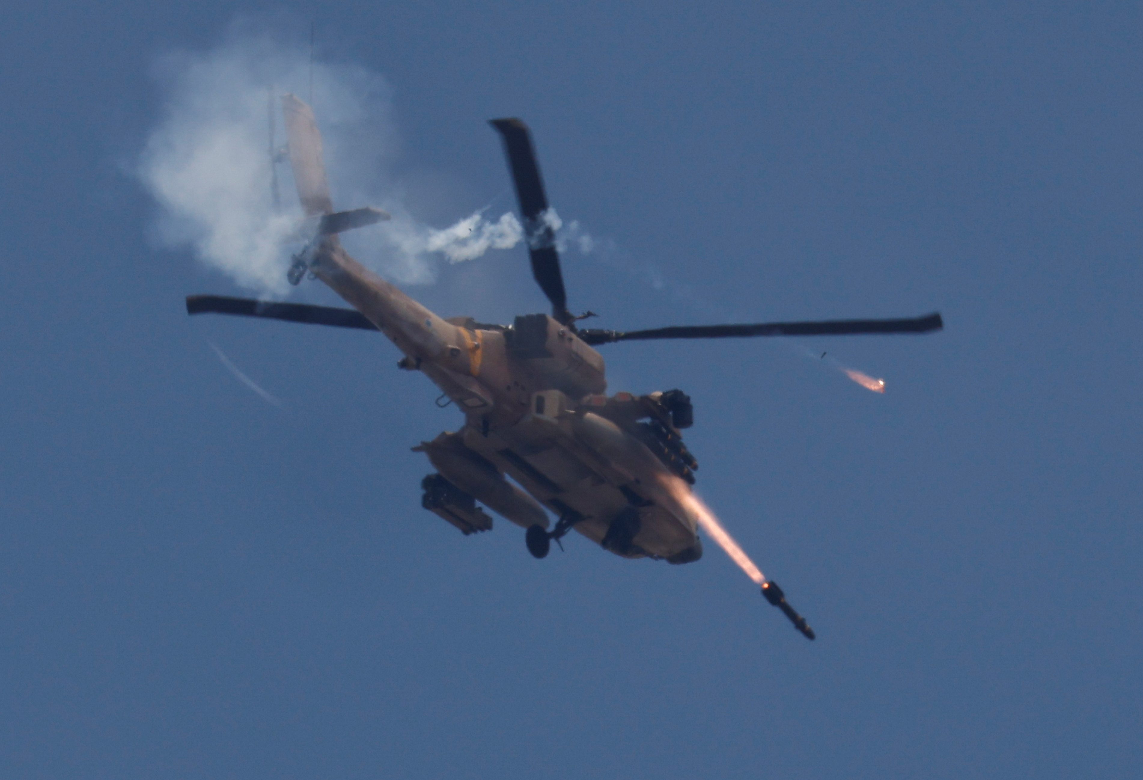 An Israeli military Apache helicopter fires missiles towards Gaza, amid the ongoing conflict between Israel and the Palestinian Islamist group Hamas, as seen from southern Israel, May 14, 2024. REUTERS/Amir Cohen