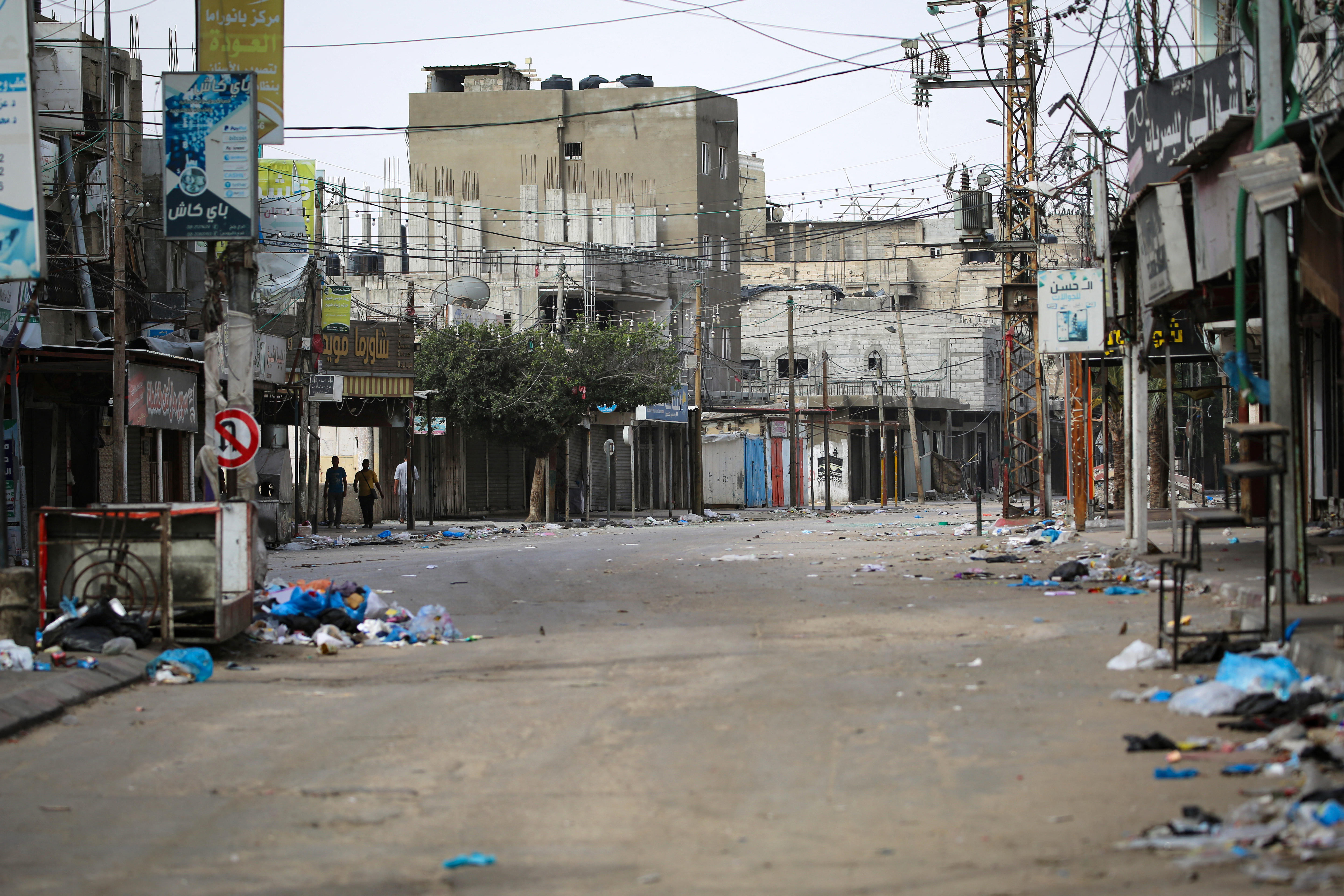 People walk along a nearly deserted street in Rafah in the southern Gaza Strip on May 11