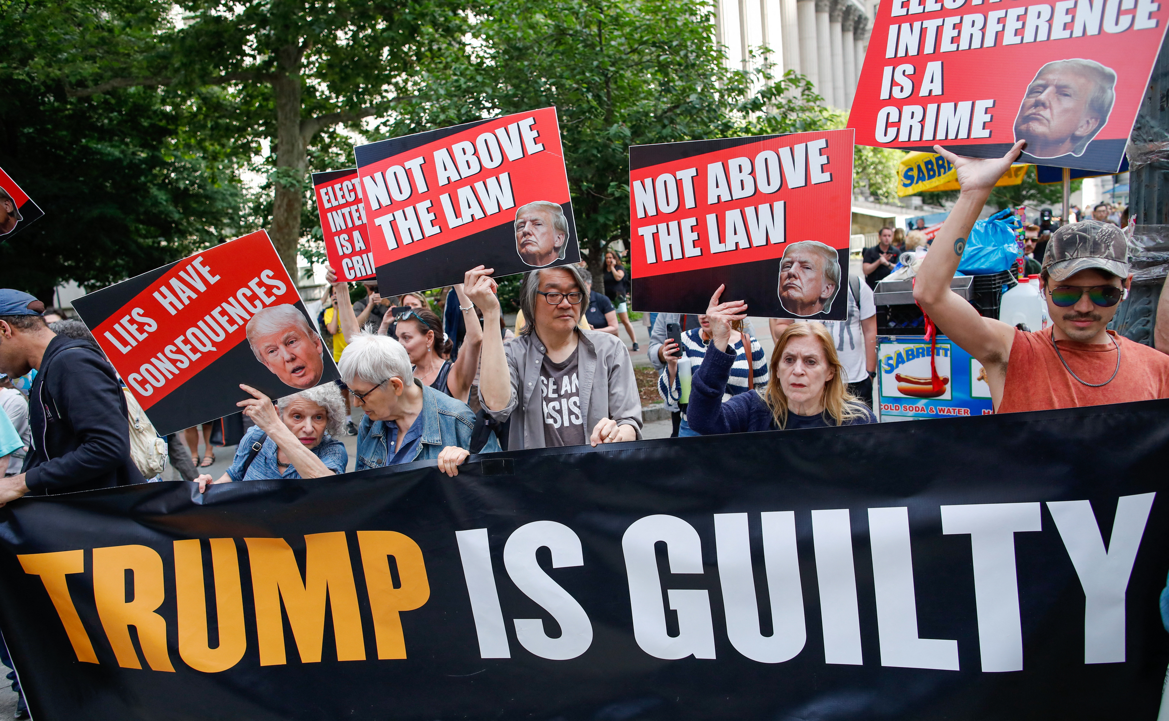 People react after former US President and Republican presidential candidate Donald Trump was convicted in his criminal trial outside of Manhattan Criminal Court in New York City