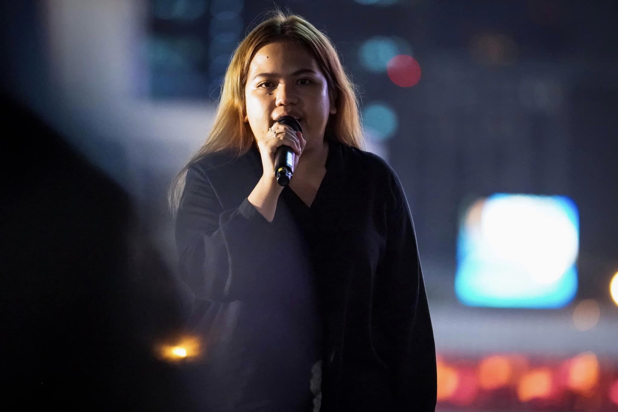 Netiporn "Bung" Sanesangkhom. She is dressed in black and speaking at a rally