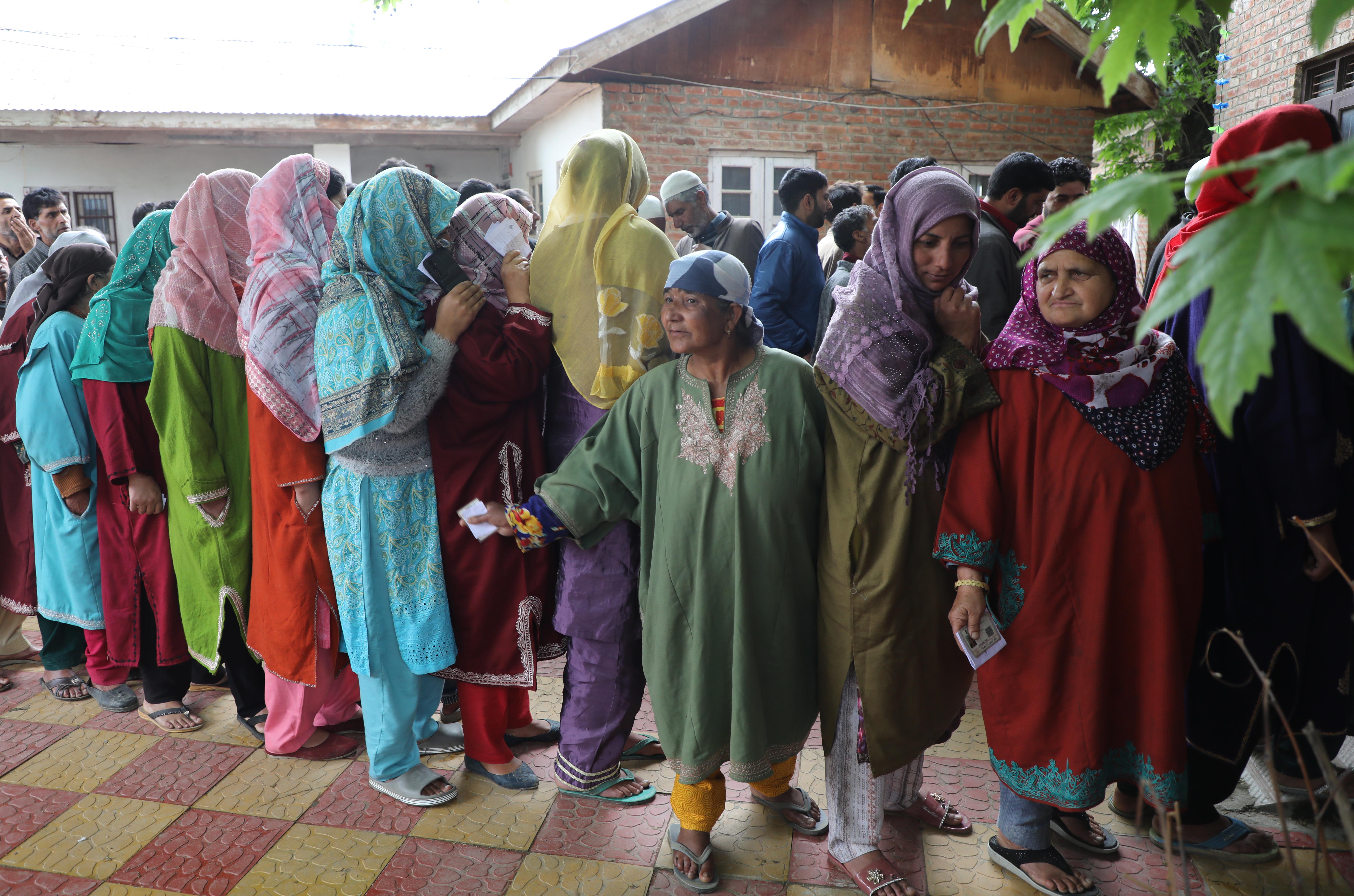 Rukhsana, third from the right, standing in a queue to cast her vote. Photo by Umer Asif