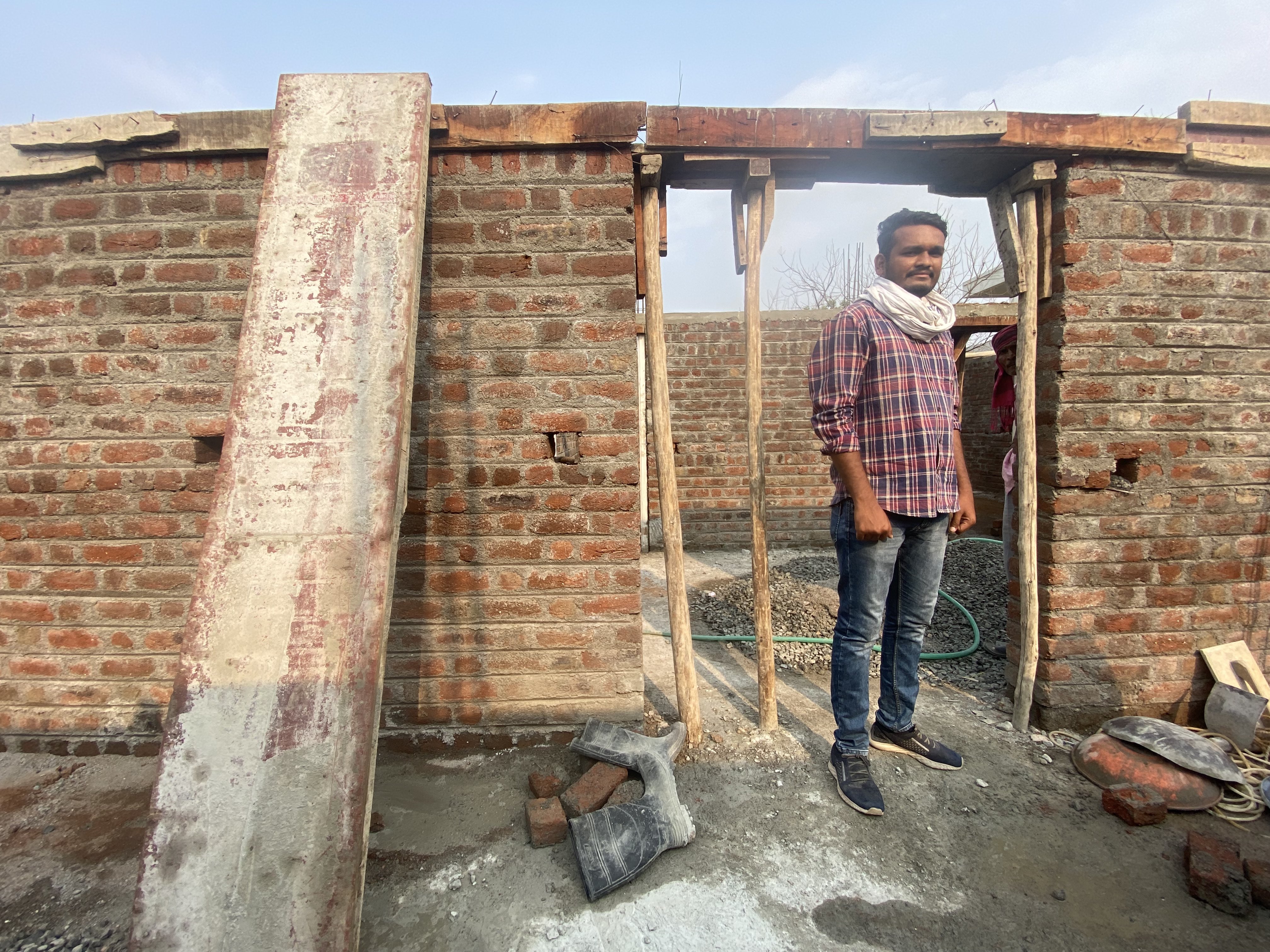 Sidhant Mende has an engineering degree. But he works supervising the construction of a house that requires none of his training and offers a pittance in pay, in Ralegaon, India [Al Jazeera/Kunal Purohit]