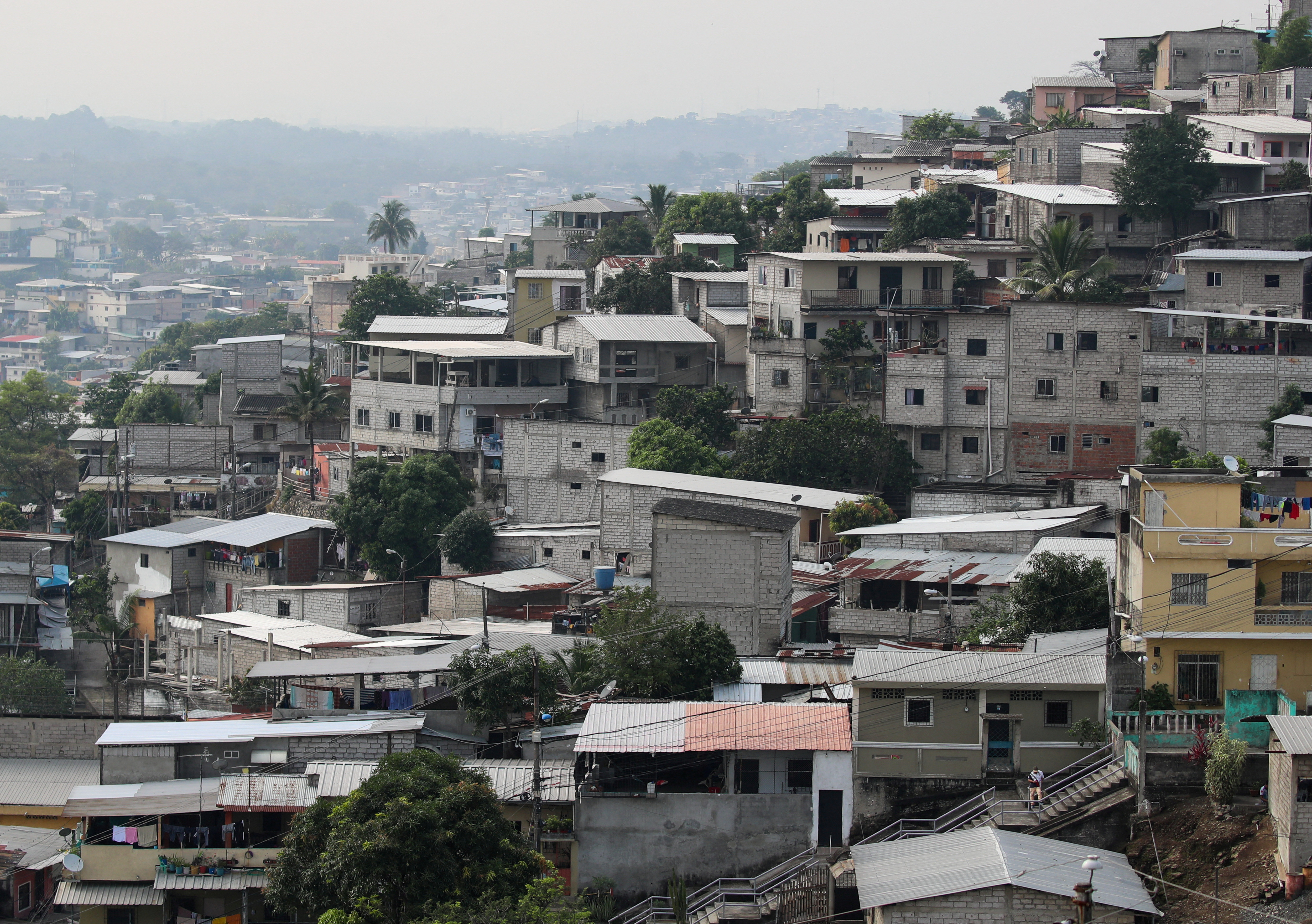 An aerial view of a neighbourhood in Guayaquil, Ecuador, with lots of flat, white multi-story buildings.